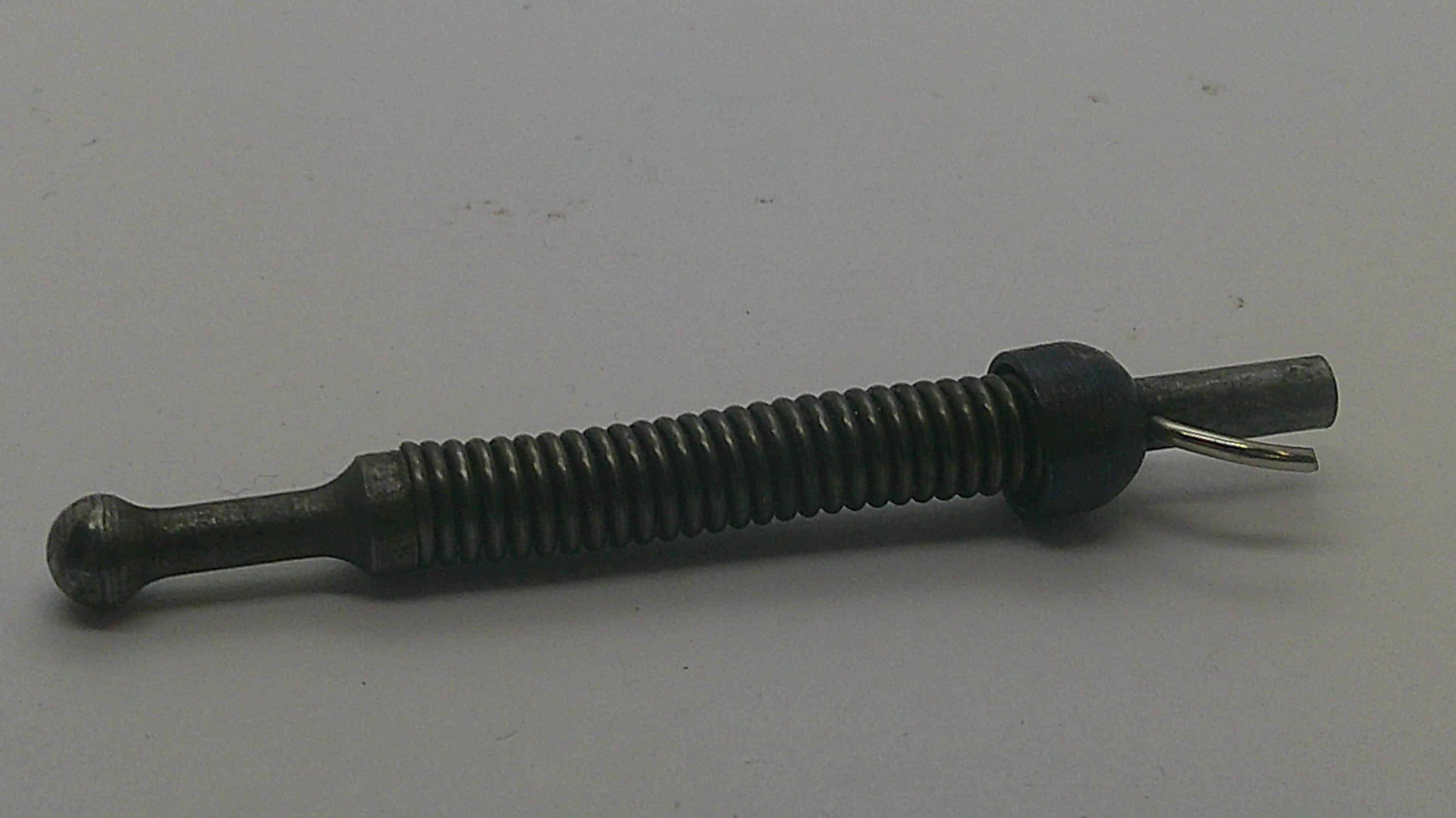 A small metal mechanical component, possibly a threaded rod or pin with a dark plastic collar and a small wire loop, shown on a plain light gray background.
