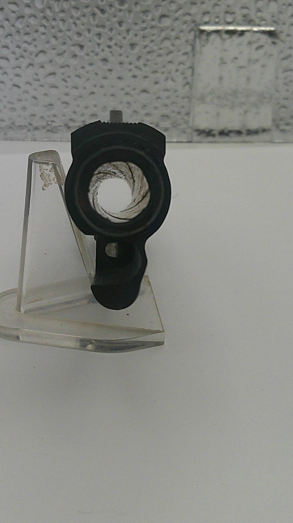 Close-up of a black mechanical component on a white background