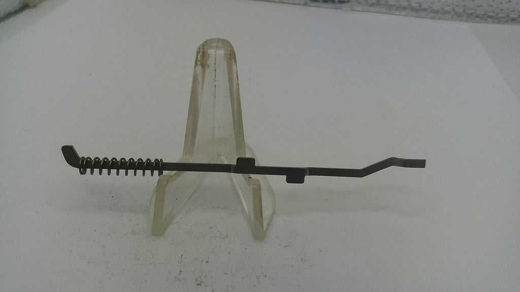 Black metal tool with bristle brush on a white background