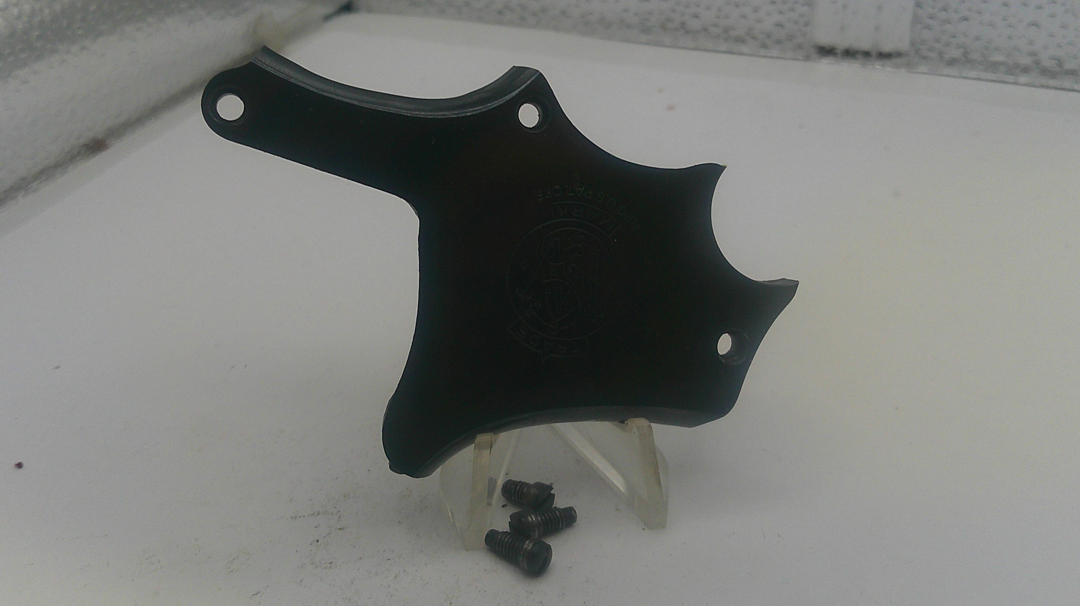 Black plastic bracket with screws on a white surface