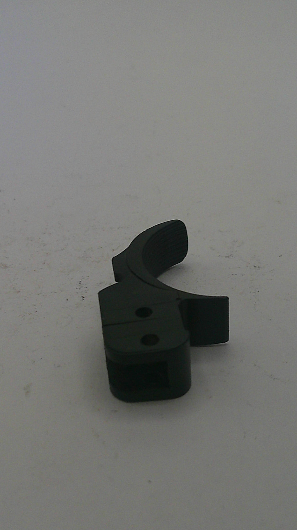 Black plastic component on a white background