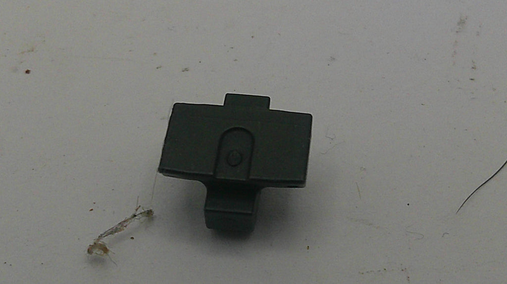 Black plastic clip on a light gray background