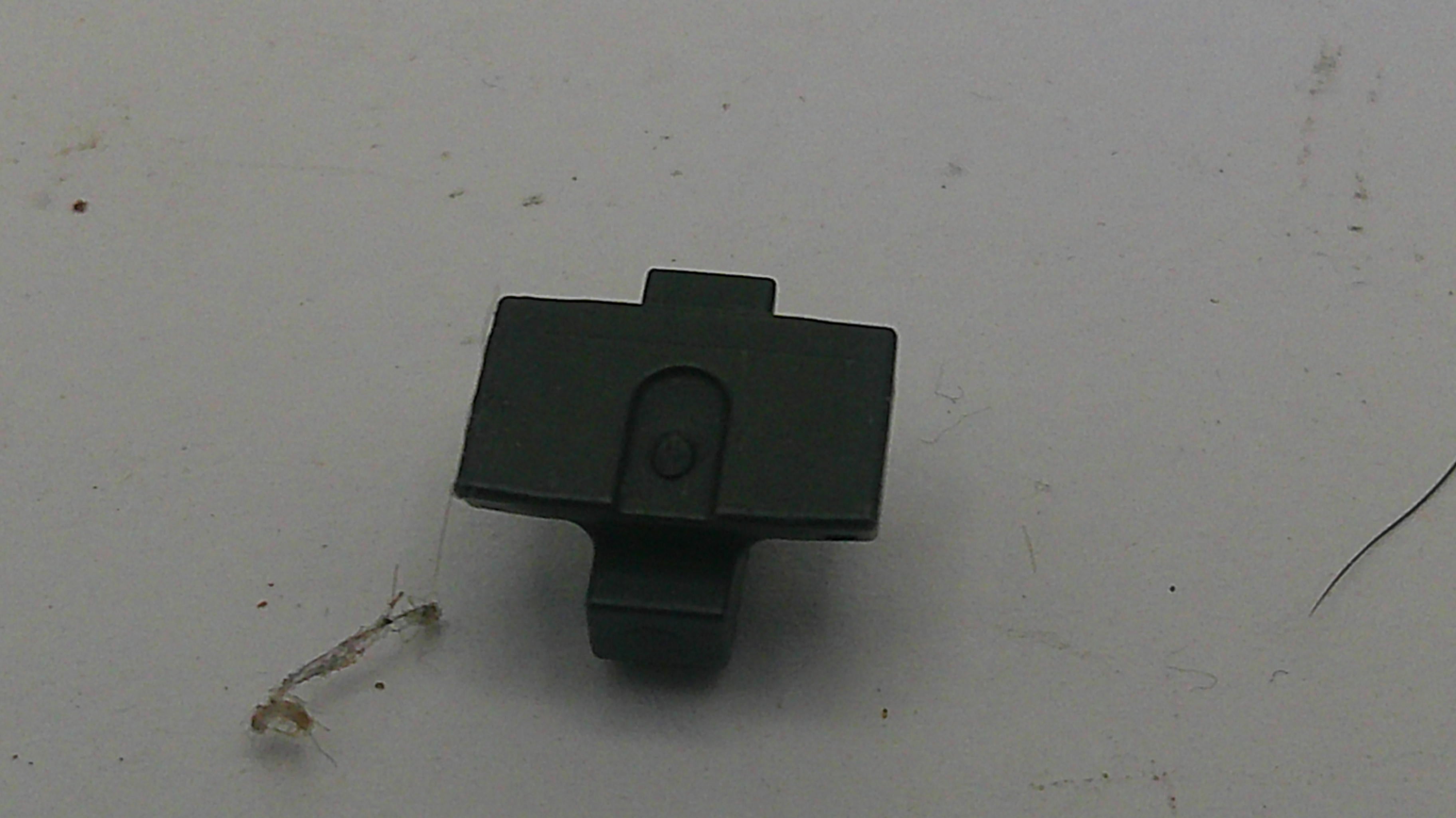 Black plastic clip on a light gray background