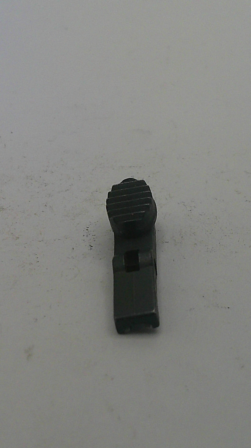 Black metal clip on a light gray background