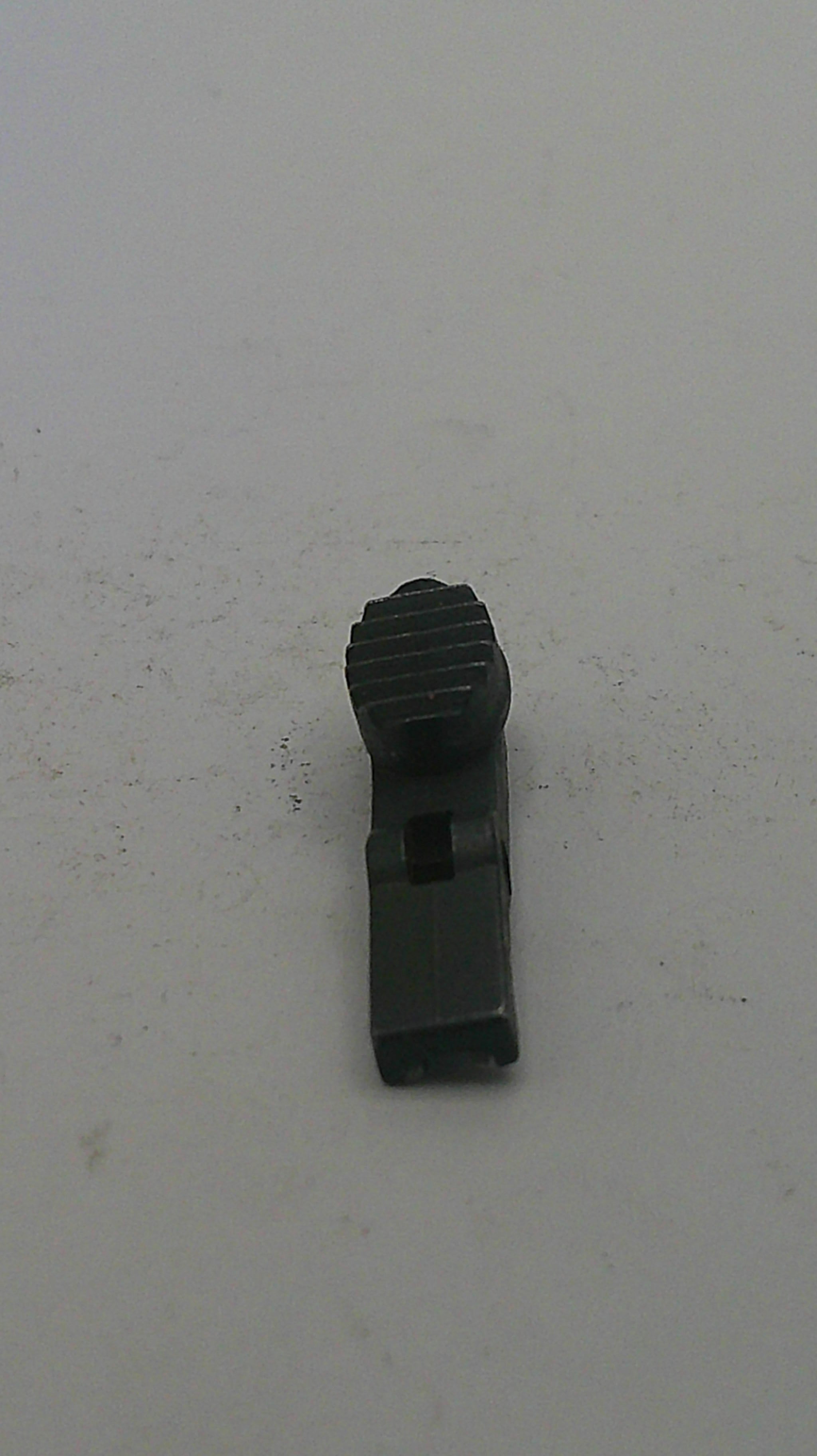 Black metal clip on a light gray background