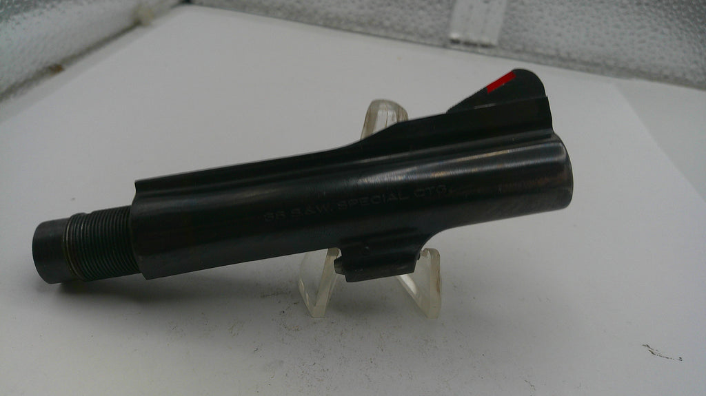 Black object on a white surface with a clear stand