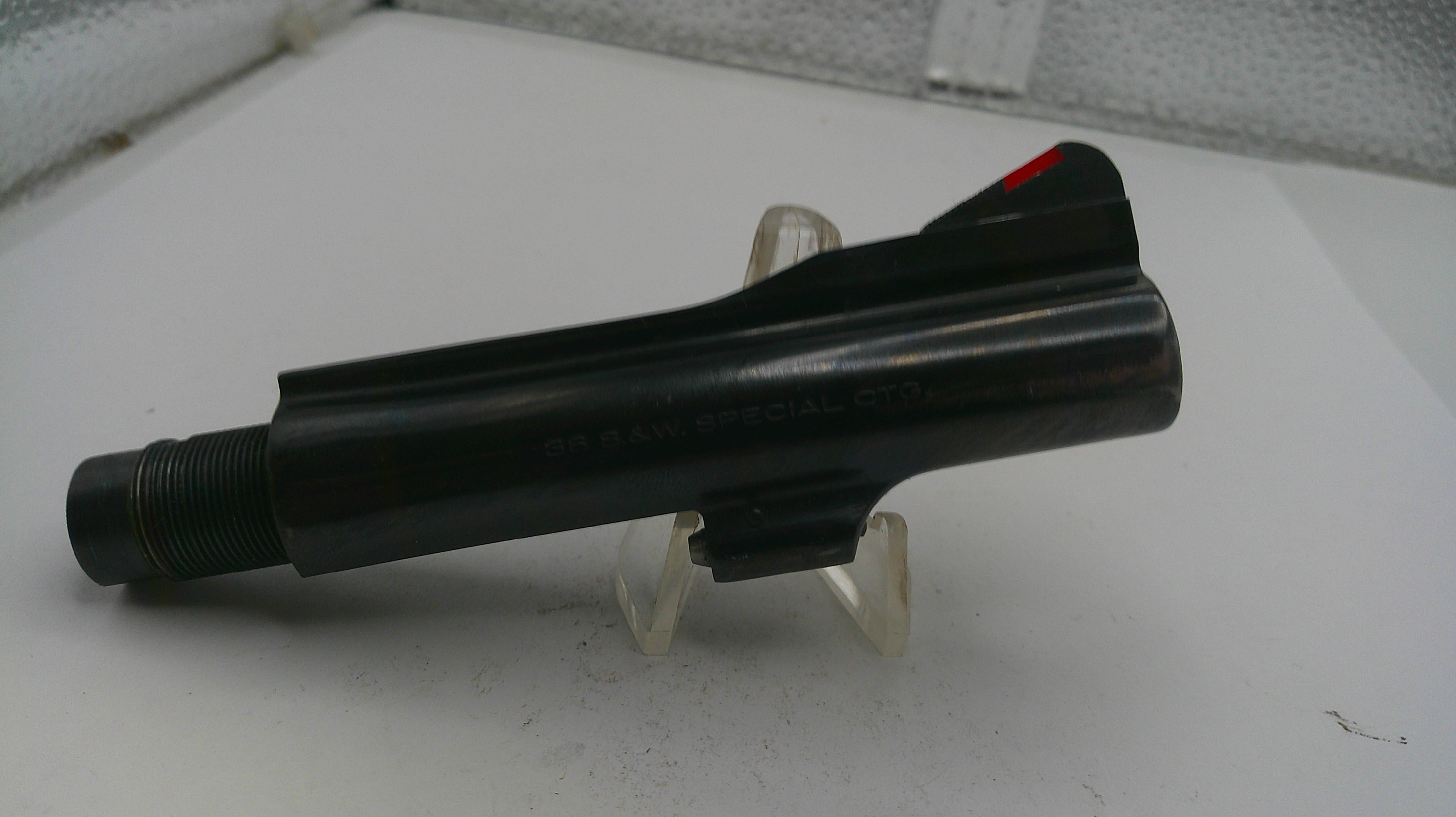 Black object on a white surface with a clear stand