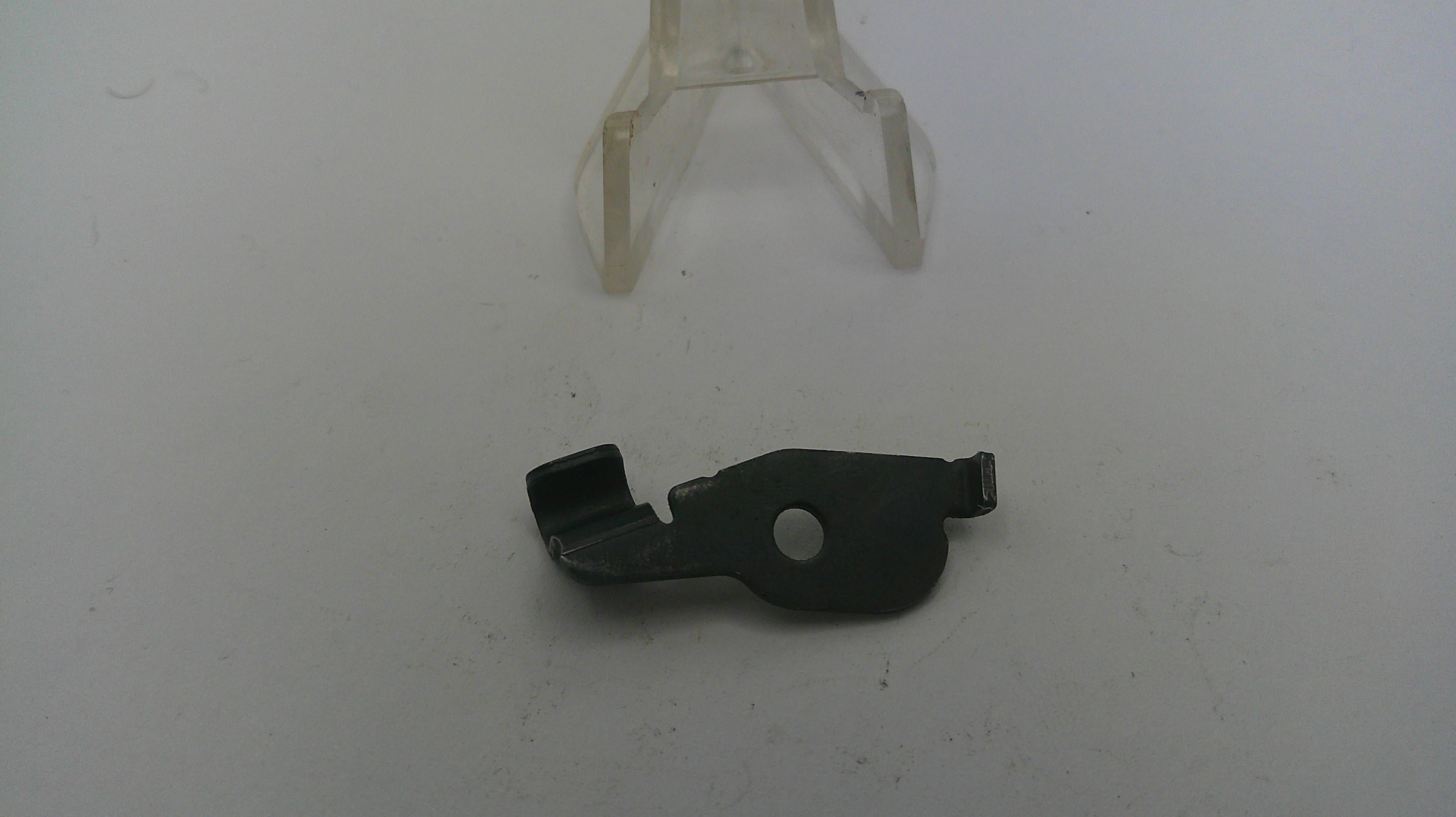 Black metal component on a white background