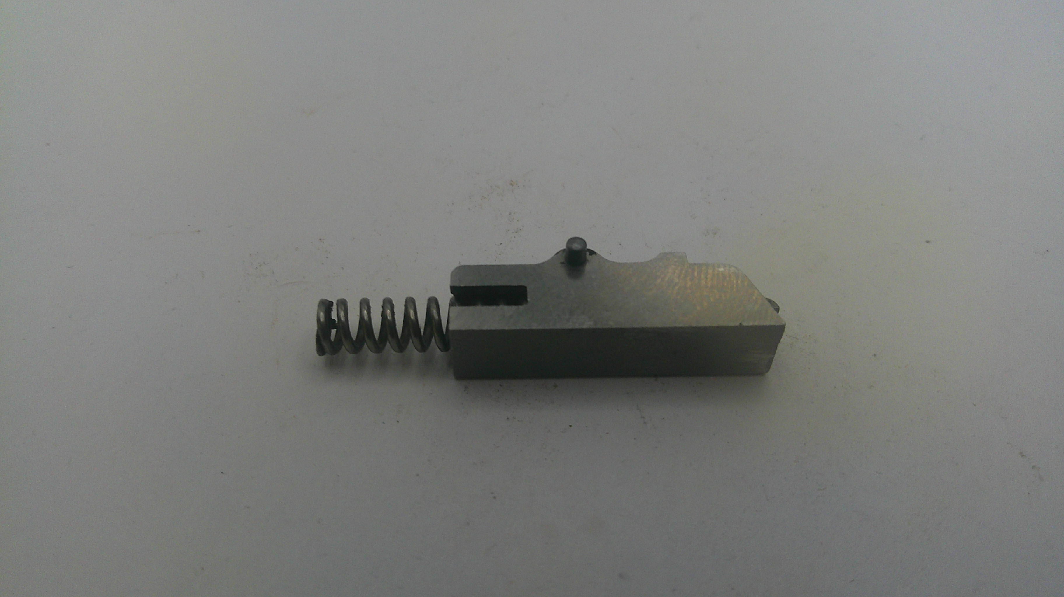 Metal component with a spring on a white background