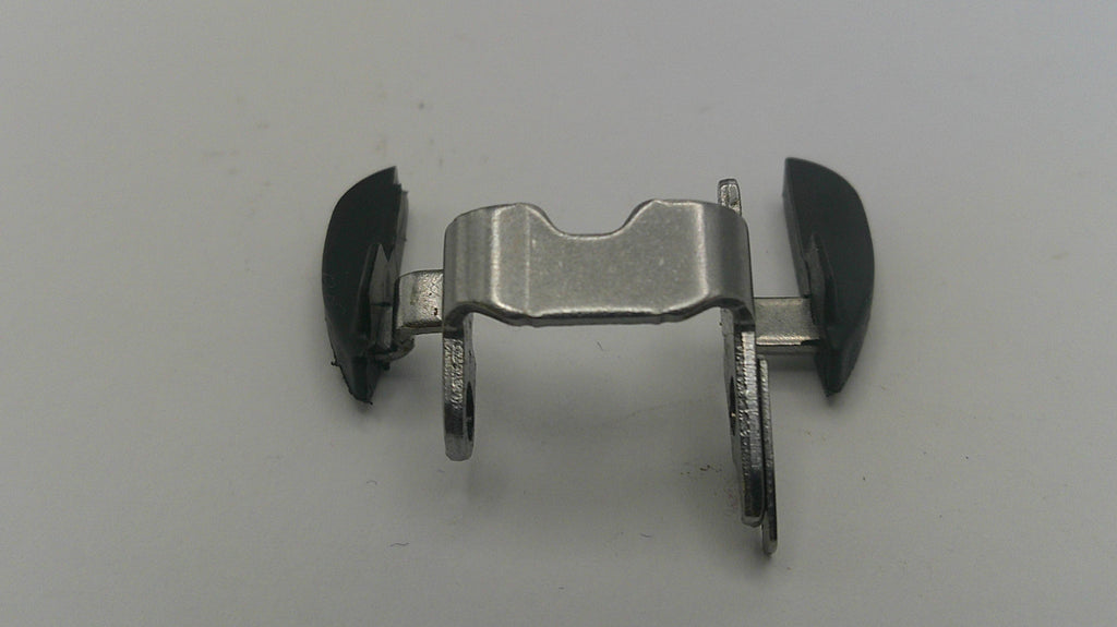 Metallic clip with black ends on a gray background