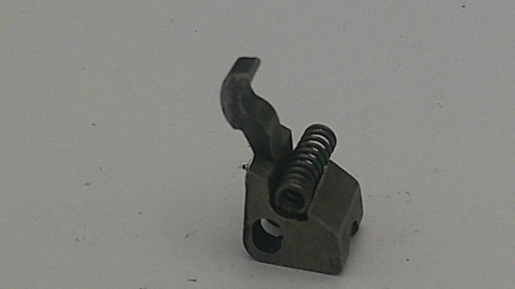 Metal component with a spring on a light gray background