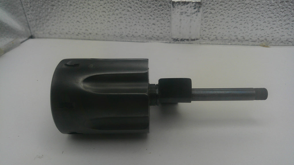 A used black plastic rotary hammer chuck with a metal shank, shown on a white surface with a textured background.