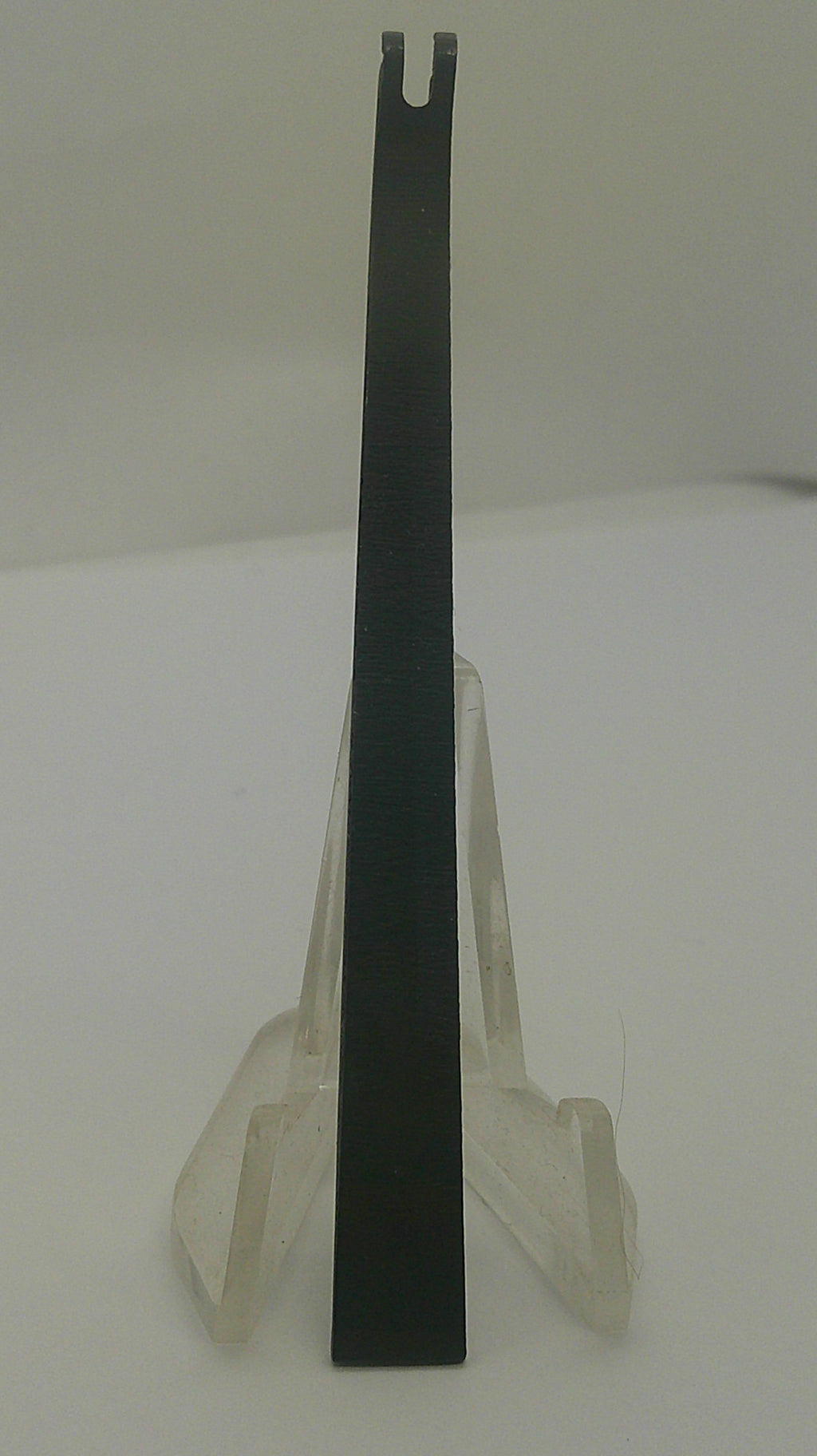 A black metal flathead screwdriver with a clear plastic protective cover, shown against a plain off-white background.