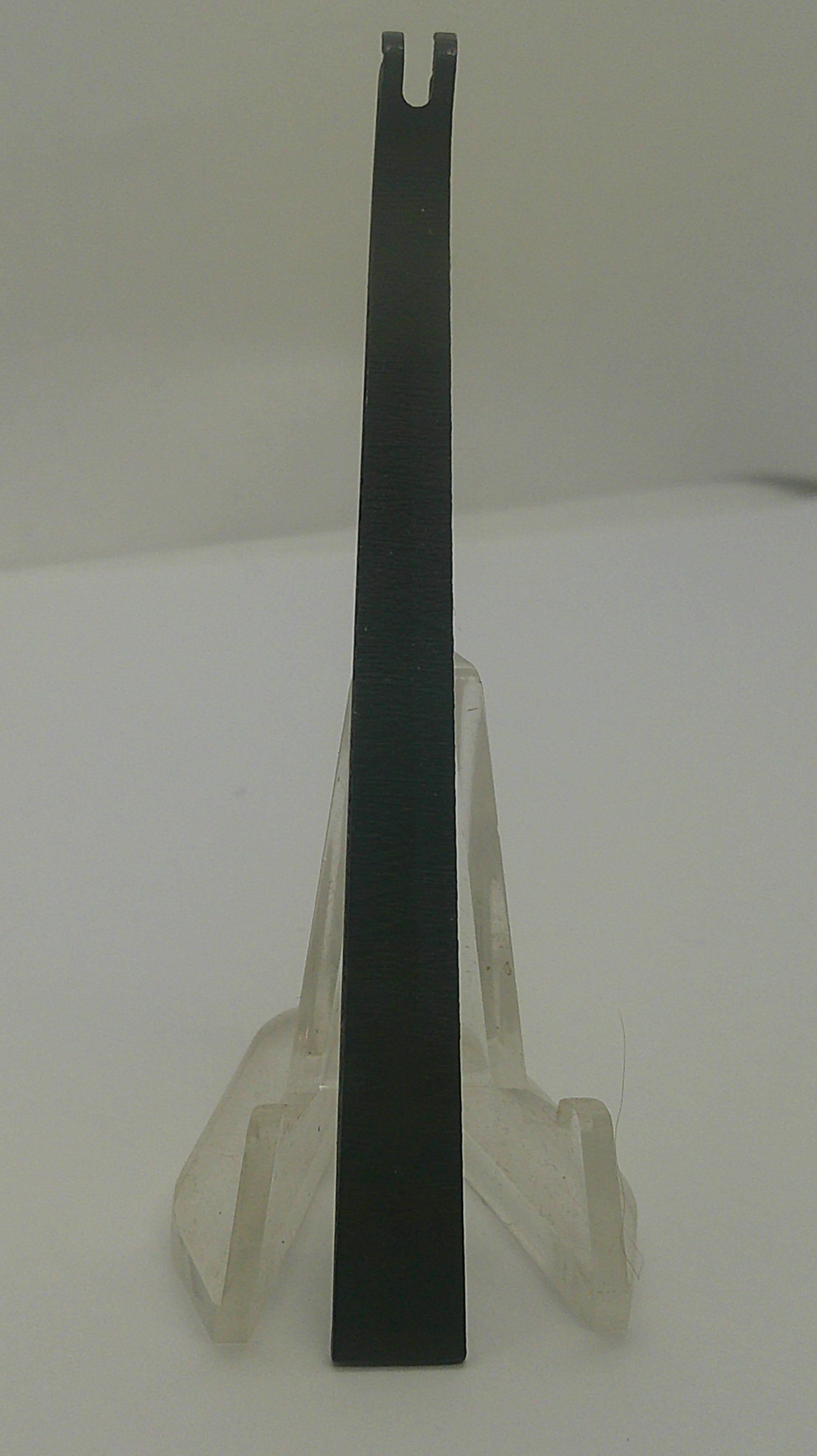A black metal flathead screwdriver with a clear plastic protective cover, shown against a plain off-white background.