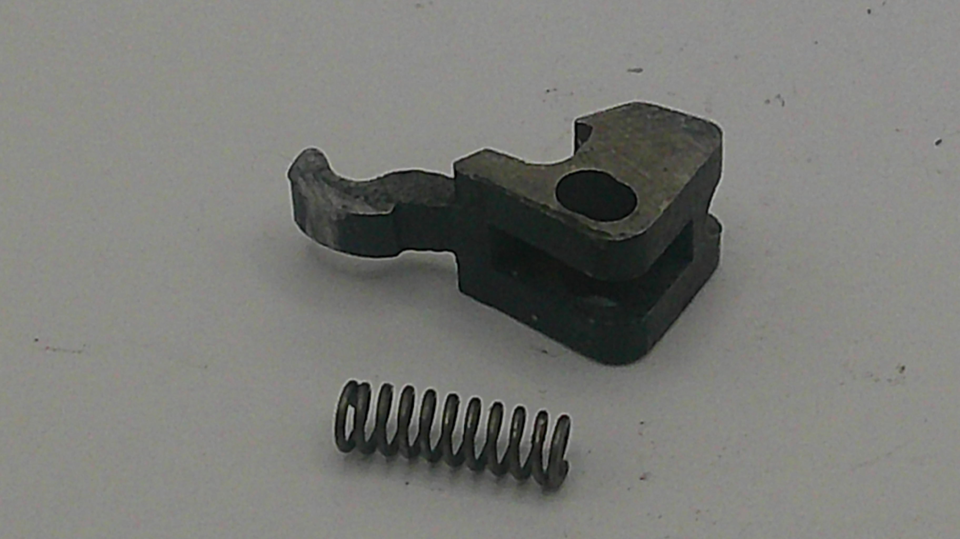 Metal component with a spring on a white background
