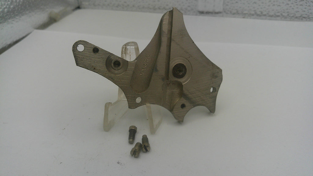 Metal mechanical part on a stand with screws on a white background