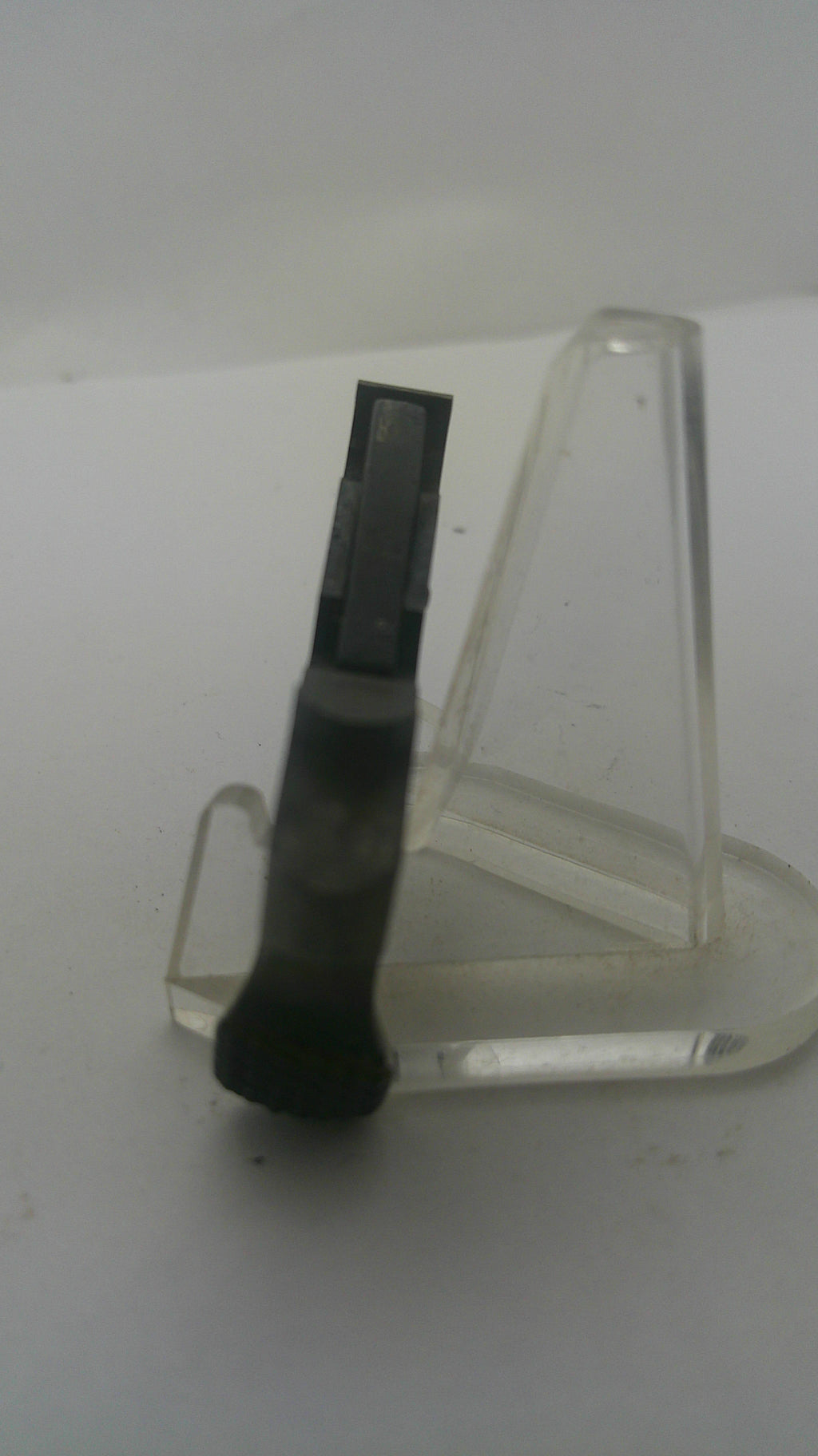A black rectangular replacement part with a translucent clear plastic holder, shown against a plain white background.