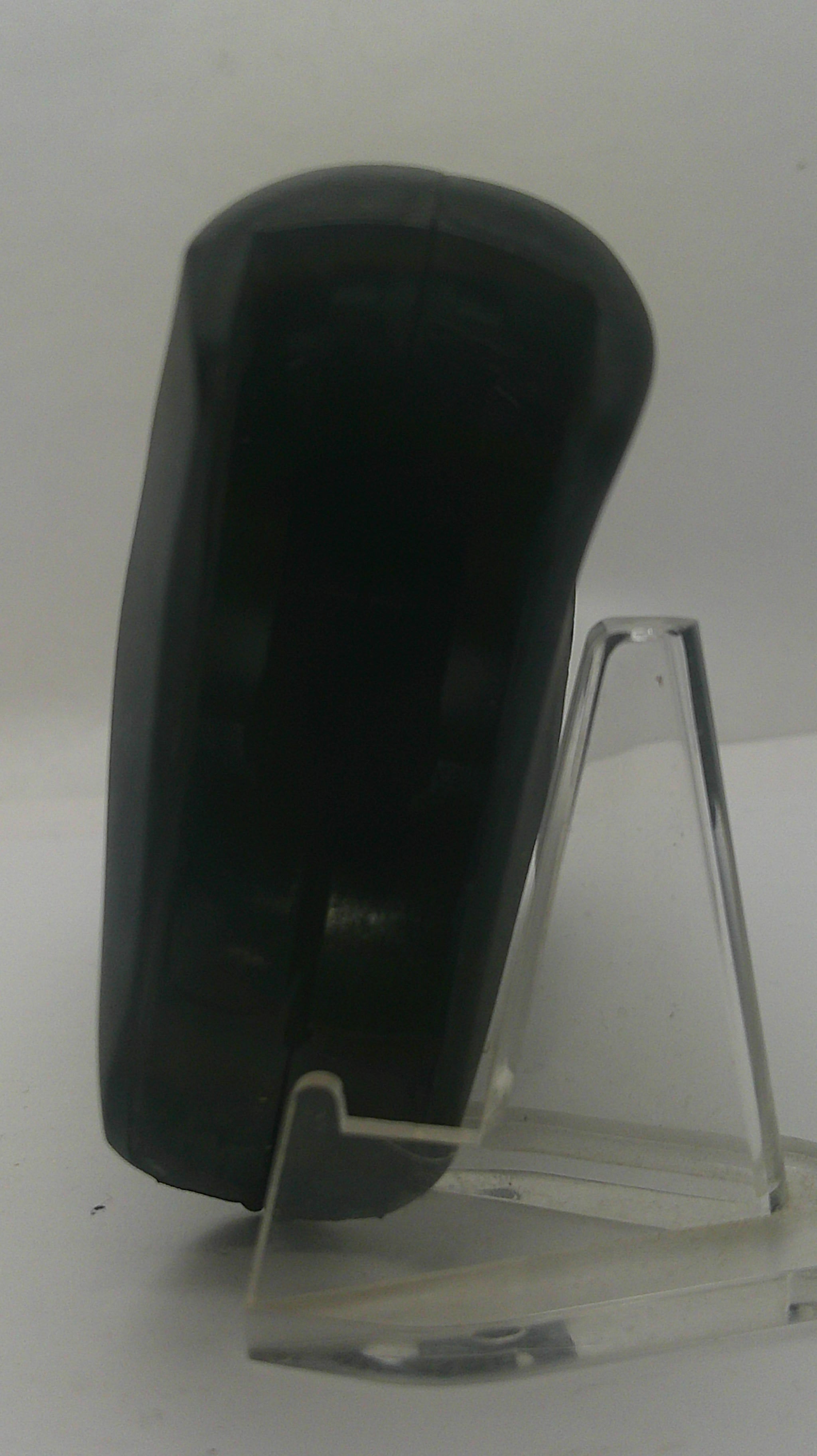 A black plastic cylindrical component, possibly a pump or valve part, mounted on a clear acrylic display stand against a plain white background.