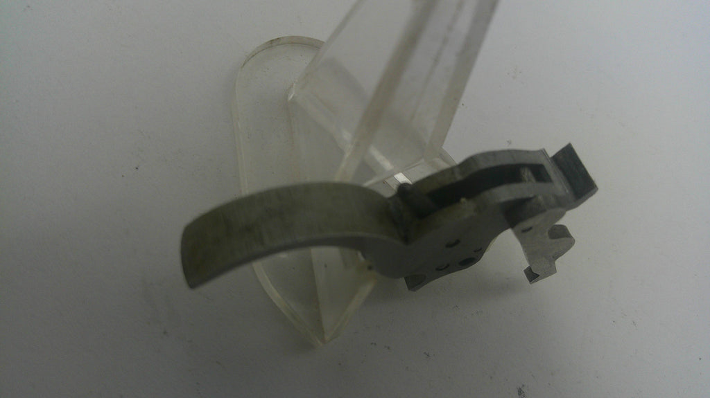 Clear plastic component with metal parts on a white background