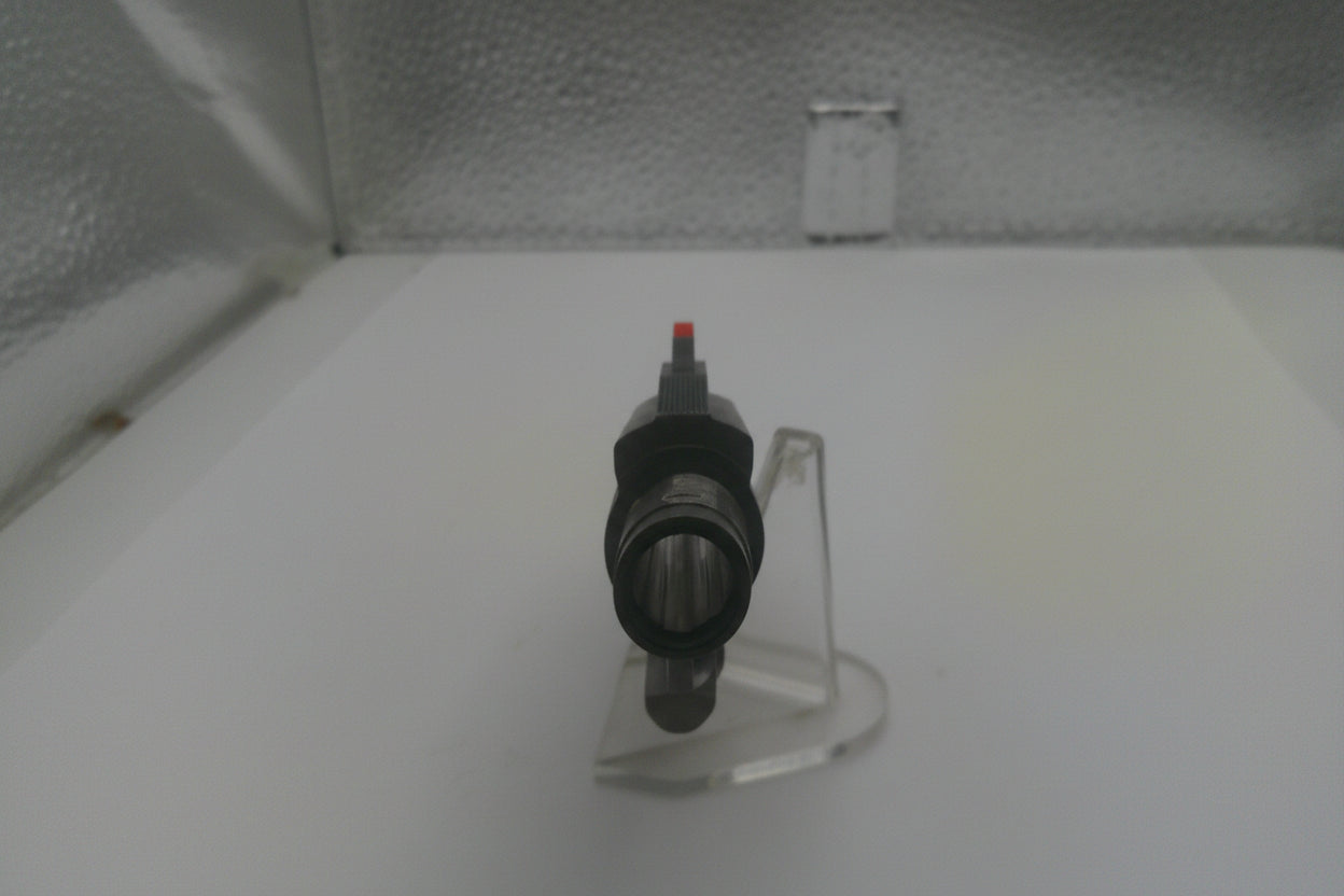 Black valve on a clear stand against a white background