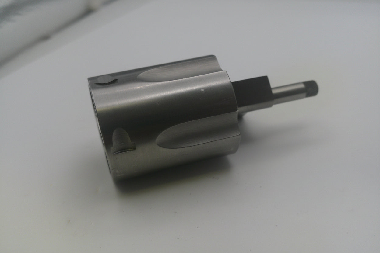 Metal cylindrical component on a white surface
