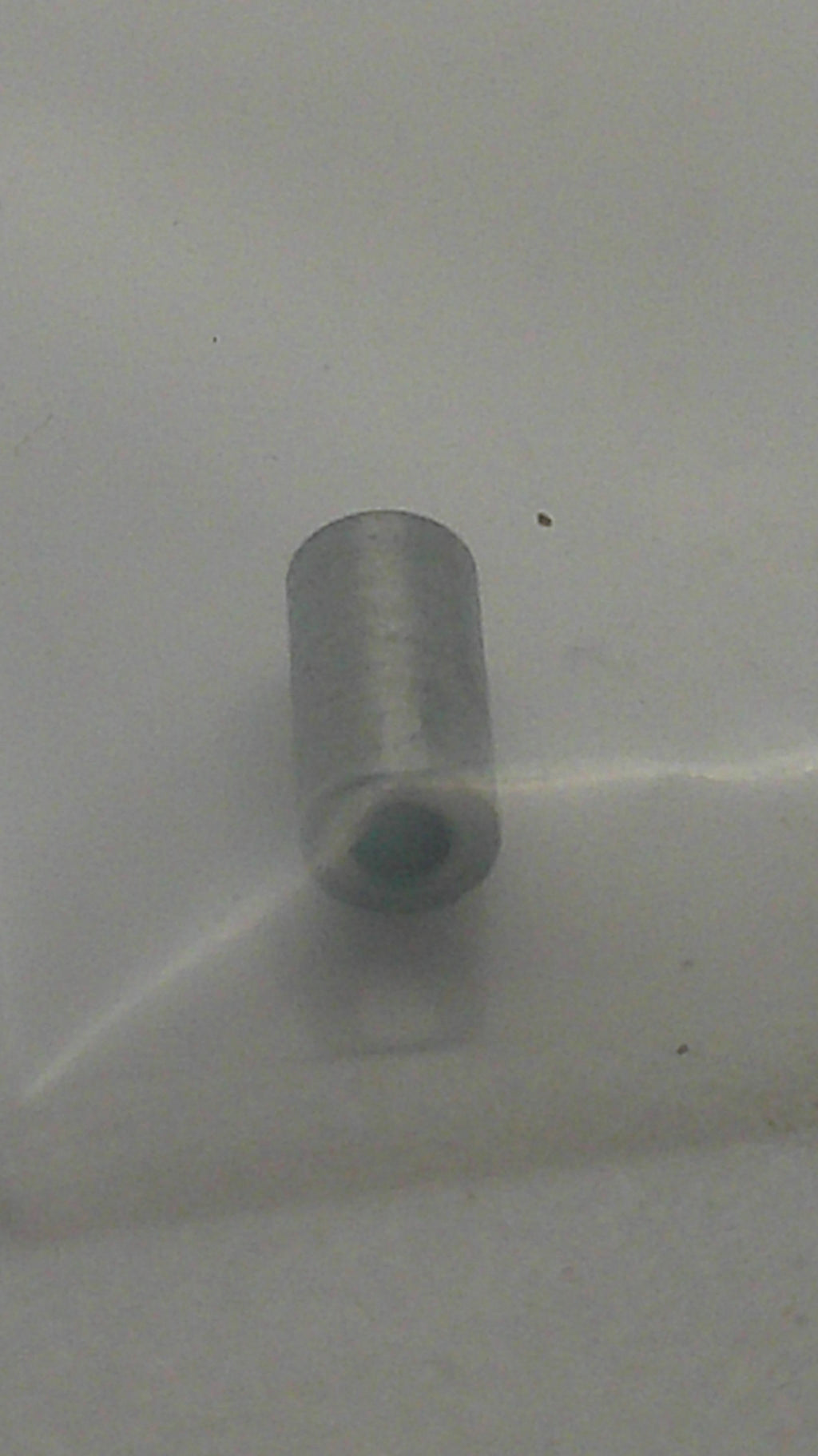 A small metallic cylindrical component with a tapered tip, shown against a plain light gray background.
