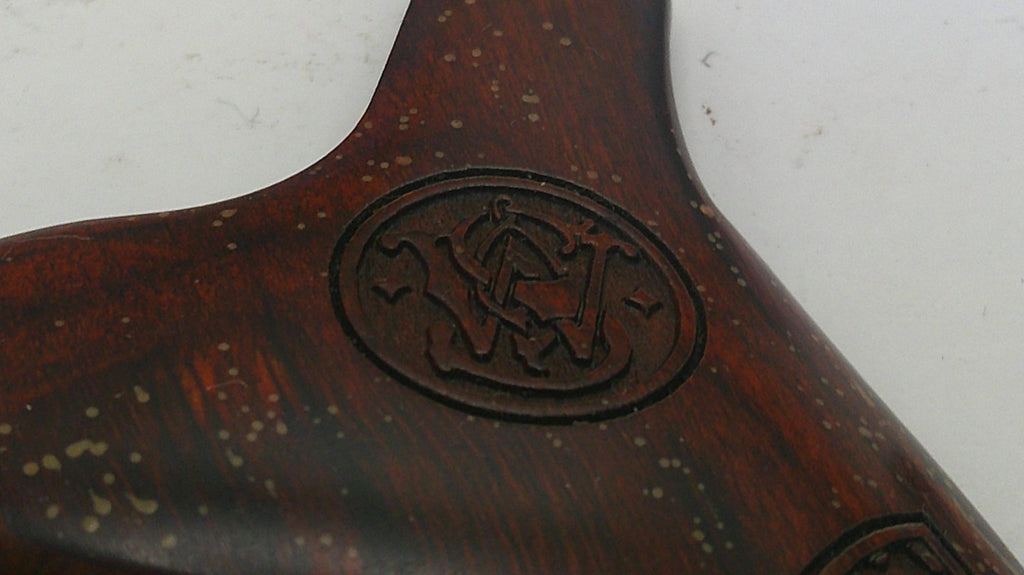 Wooden object with a logo or emblem on a white background