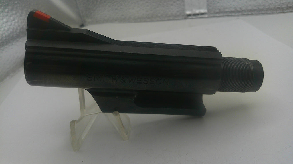 Black drill bit on a white stand with a white background