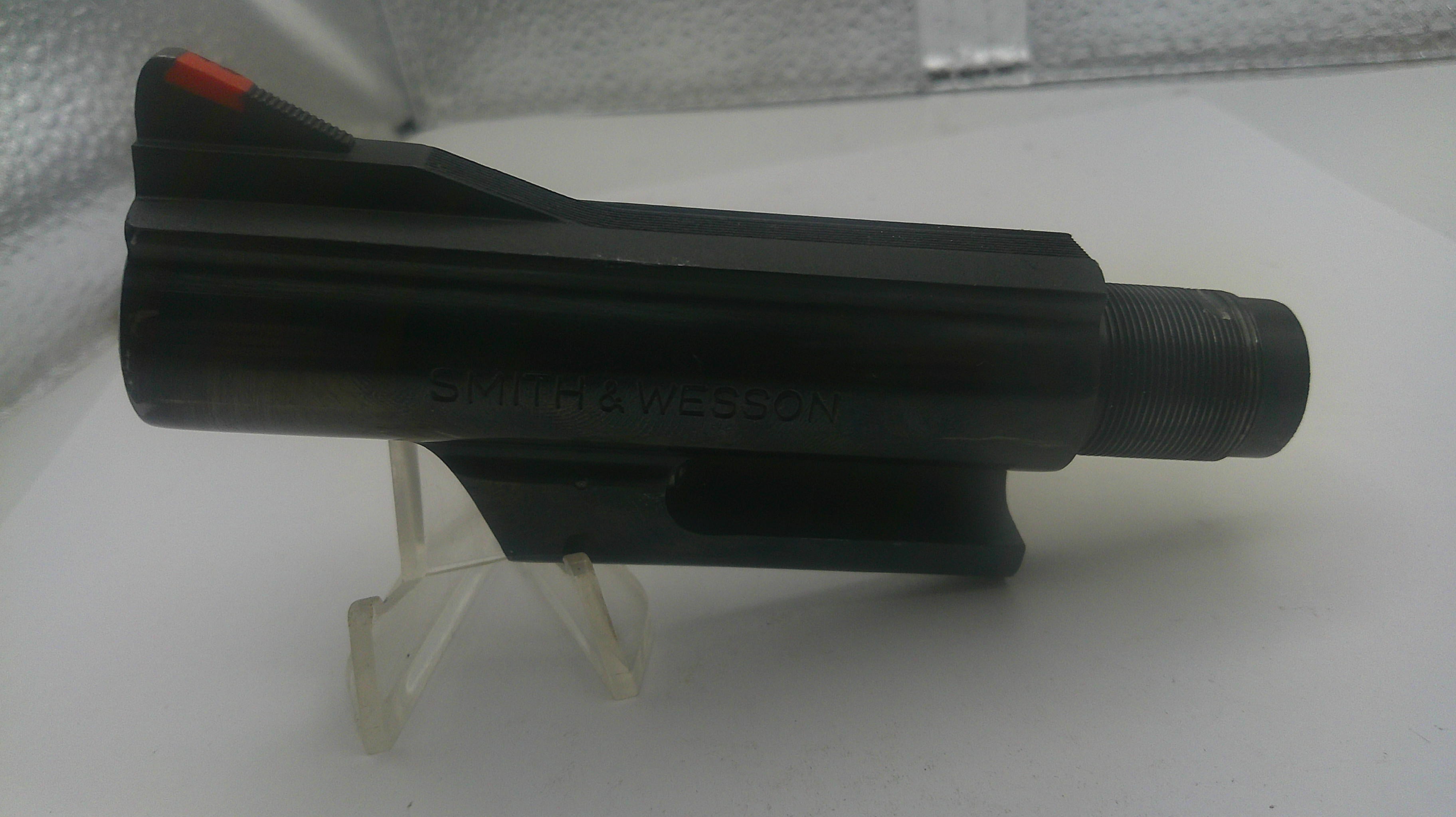 Black drill bit on a white stand with a white background