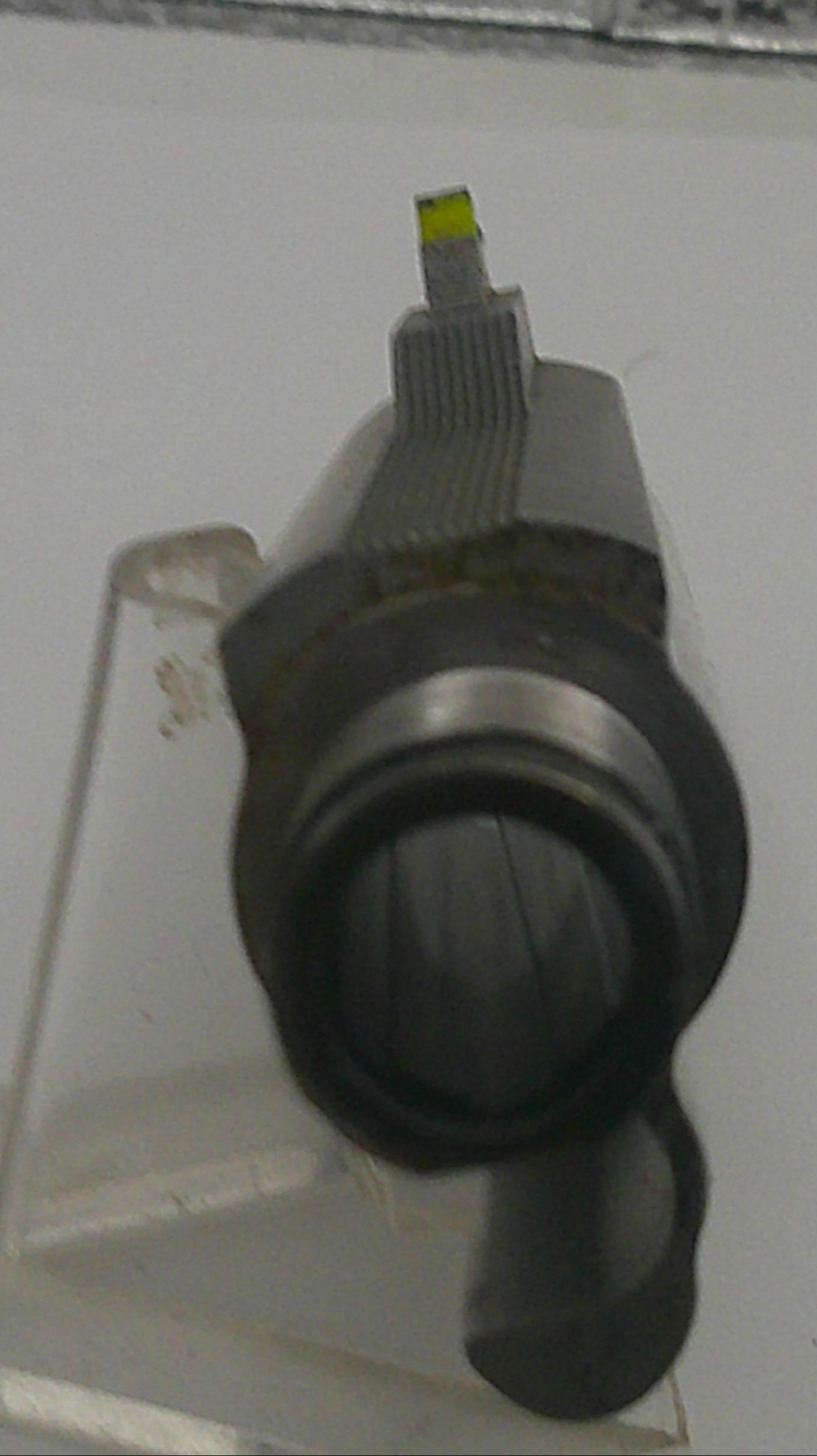 Close-up of a USB connector being inserted into a device on a textured surface.