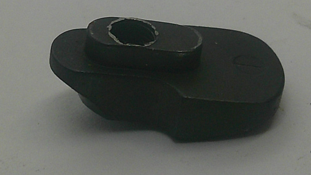 A small black plastic or rubber mechanical component with a circular hole in the center, photographed on a plain light background.