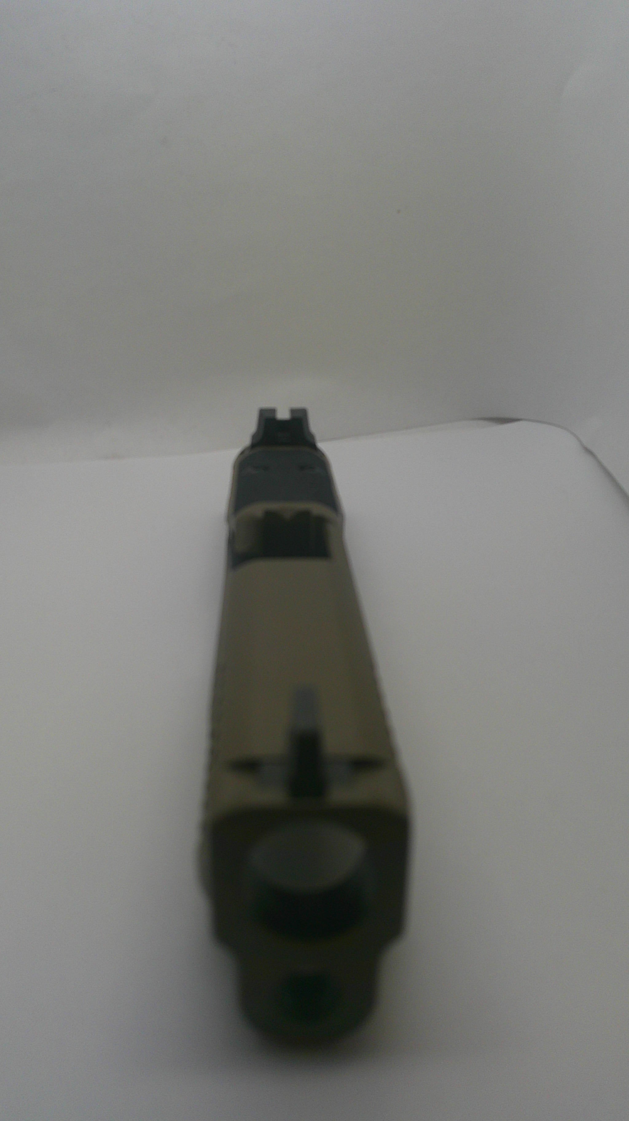 A tactical pistol grip or handguard component in olive drab and black, photographed on a plain white surface.