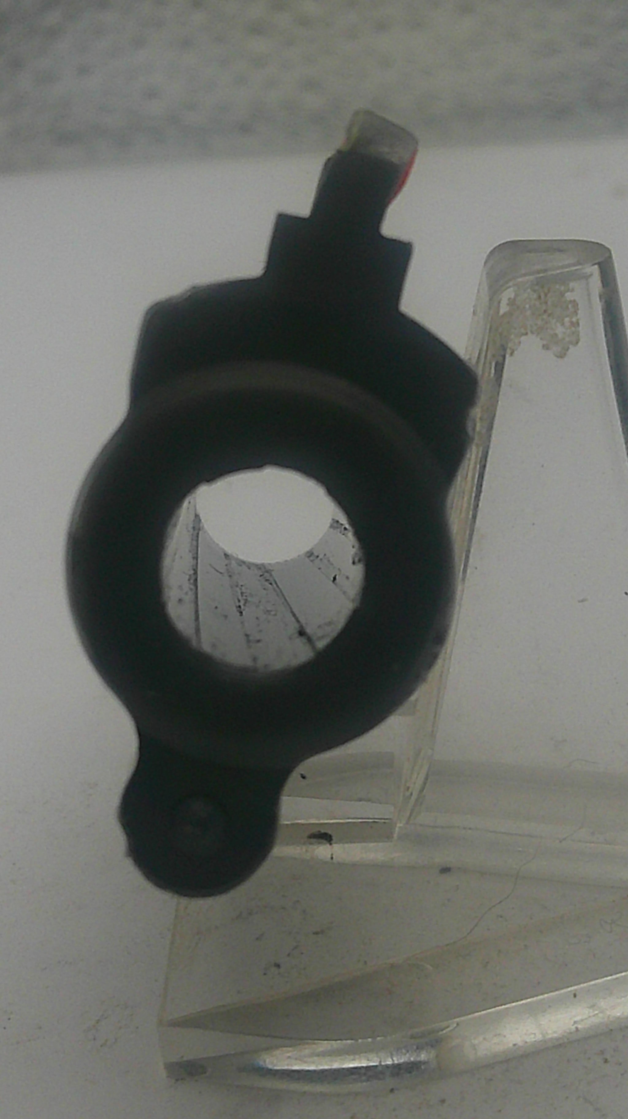 Black mechanical component on a white background