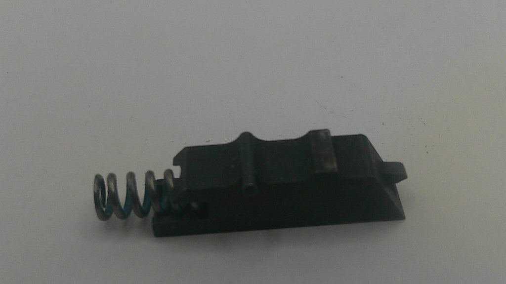 Black metal component with a spring on a white background