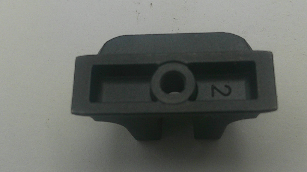 A small black plastic component with a circular hole in the center and the number 2 printed on the side, photographed on a plain light background.