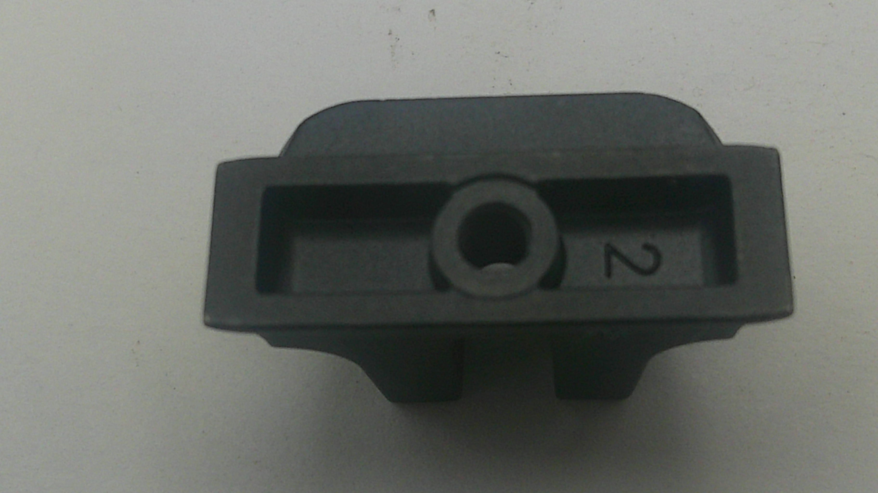 A small black plastic component with a circular hole in the center and the number 2 printed on the side, photographed on a plain light background.