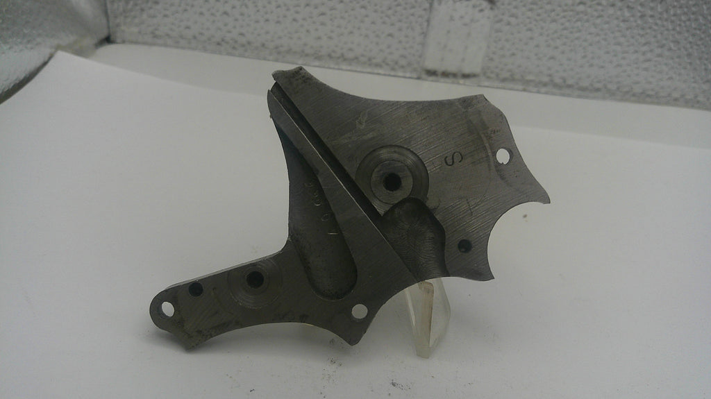 Metal mechanical part on a white surface with a textured background