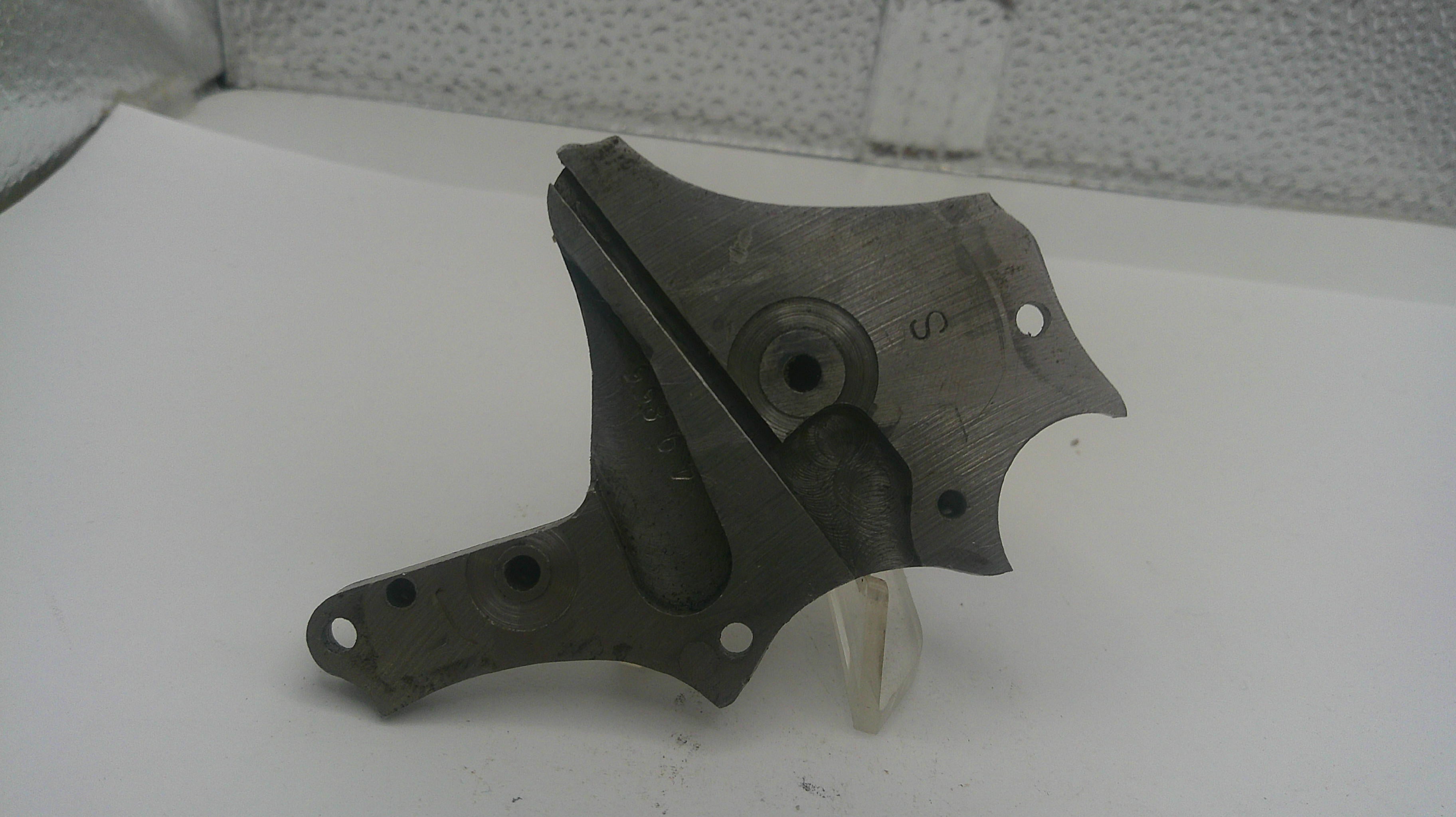 Metal mechanical part on a white surface with a textured background