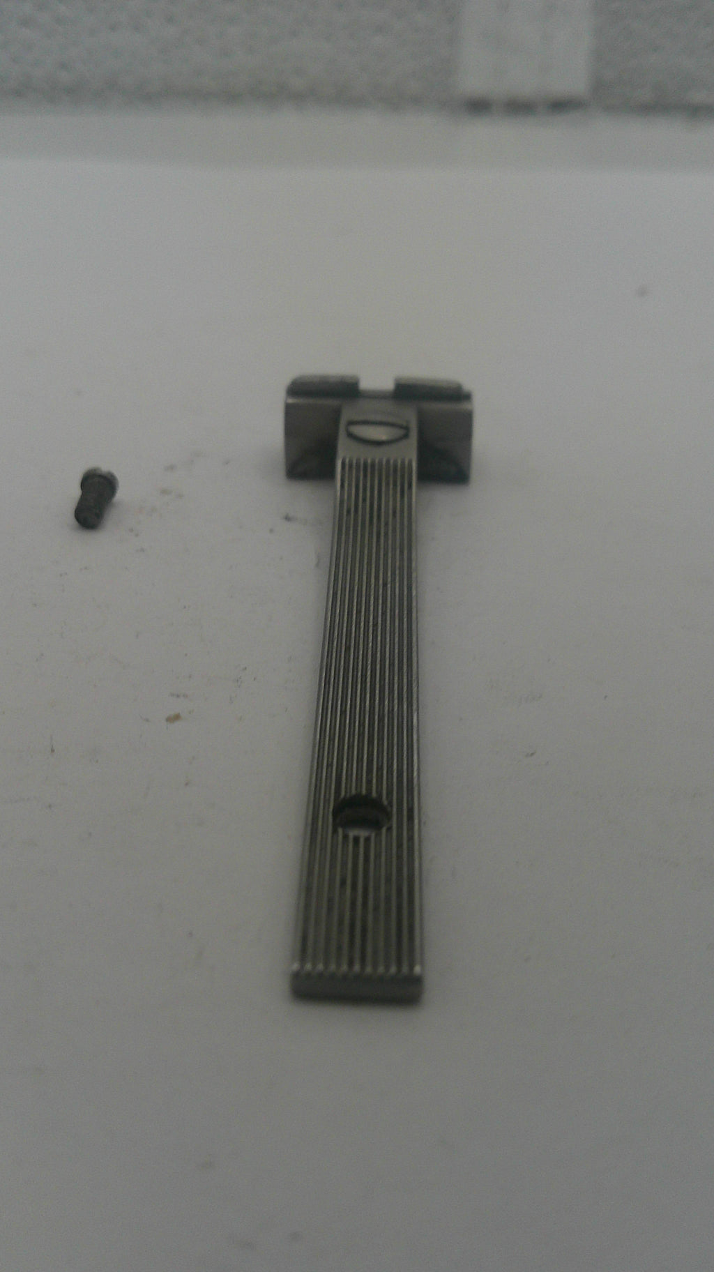 Metallic object on a white surface