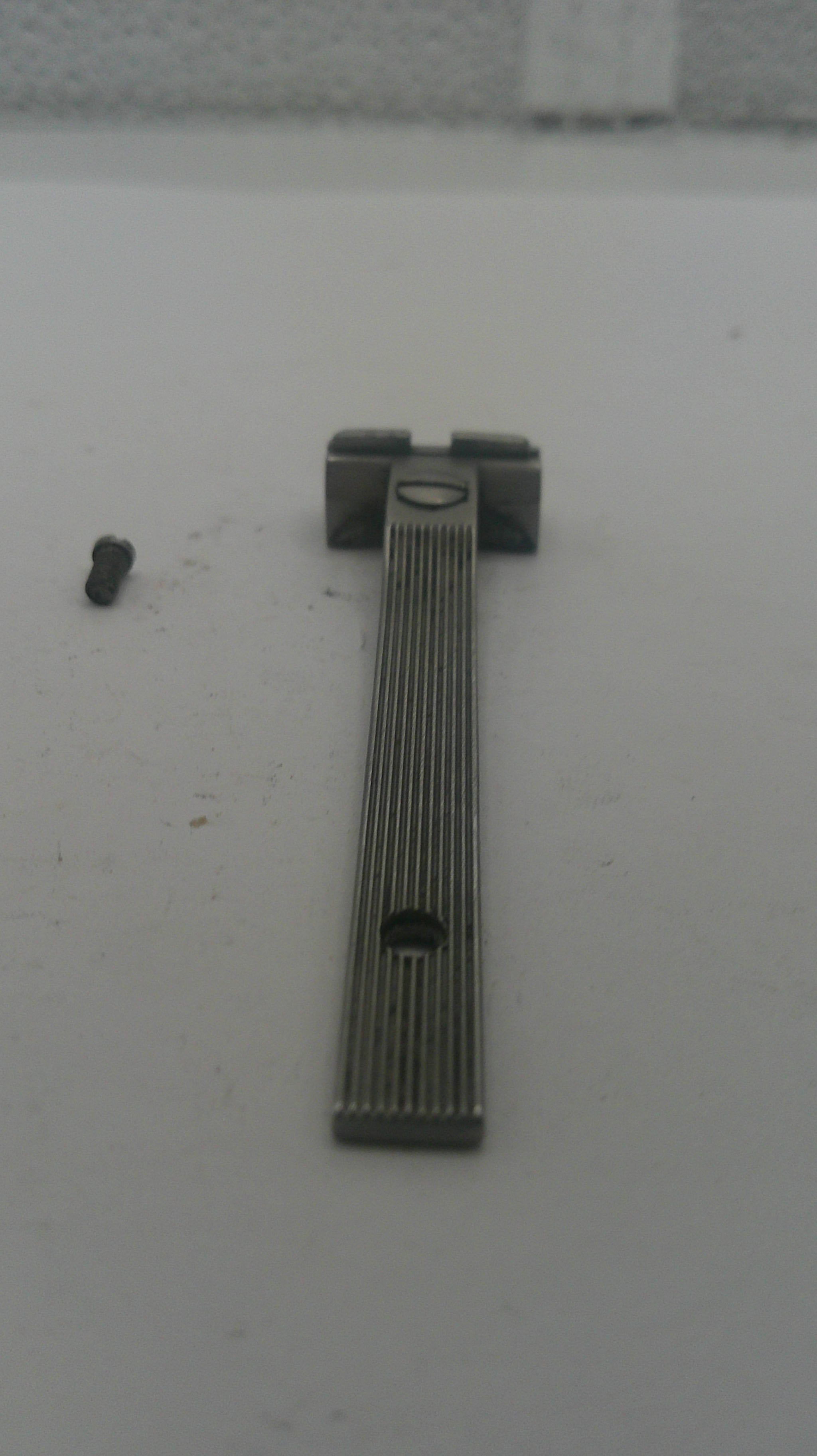 Metallic object on a white surface