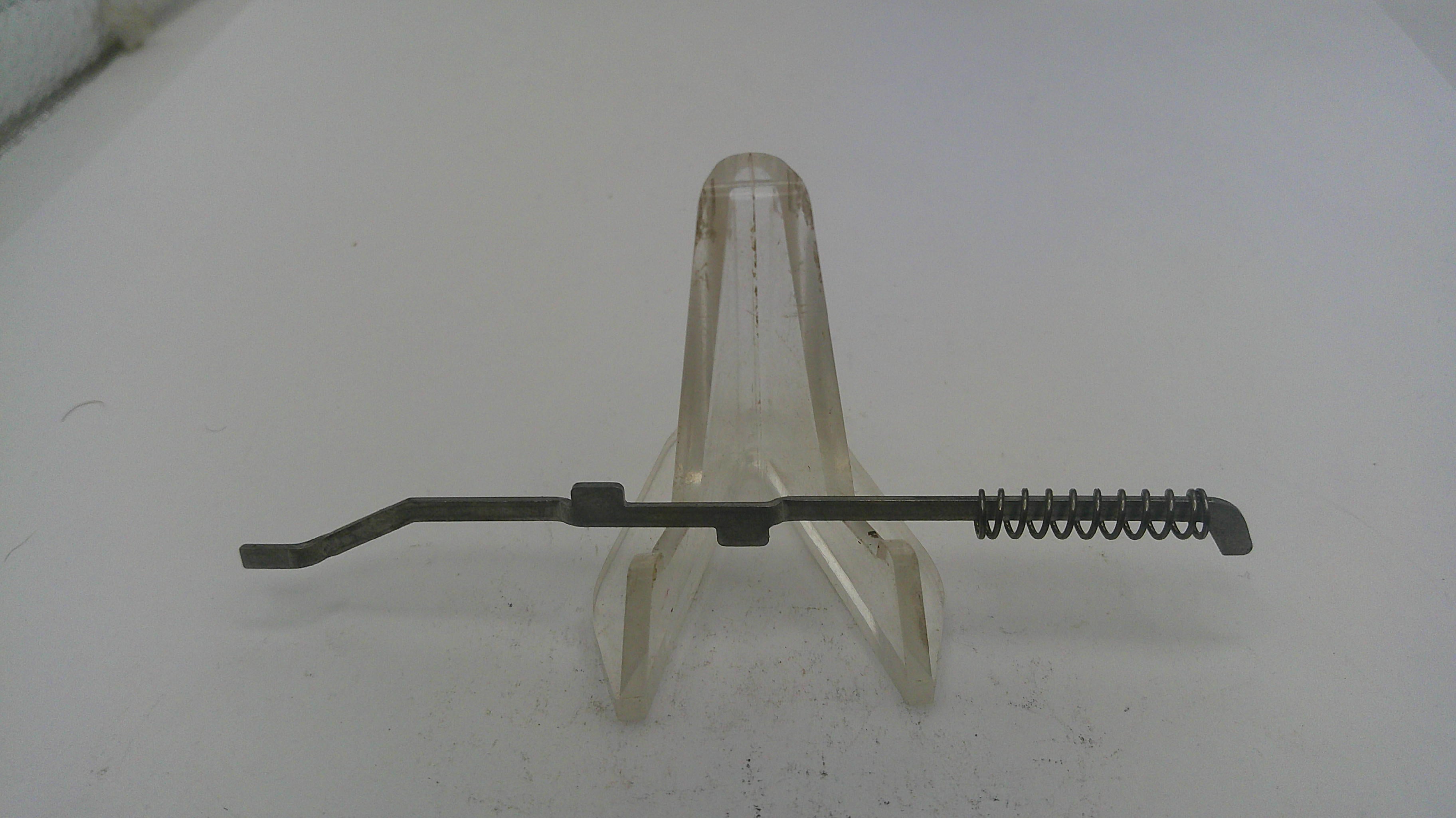 Metal tool with a spring on a white background