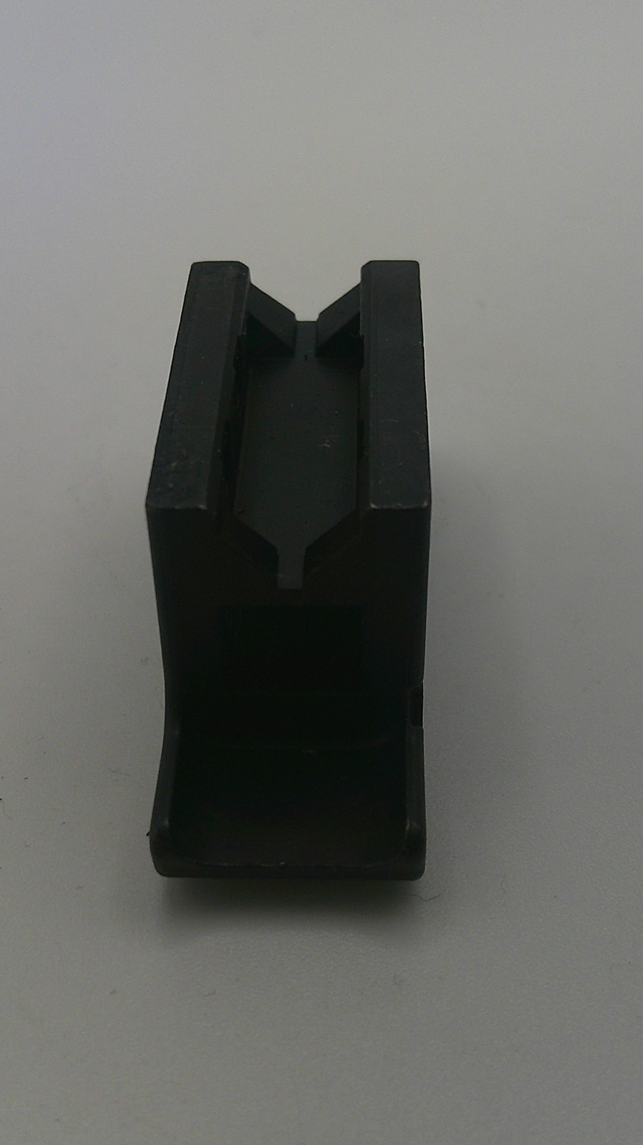 Black plastic component on a white background