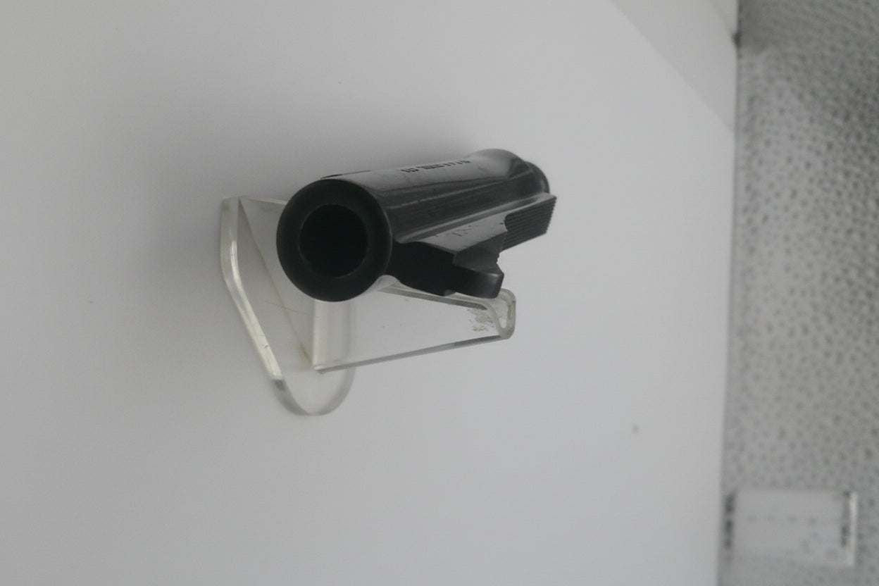 Small black and clear plastic component on a white background