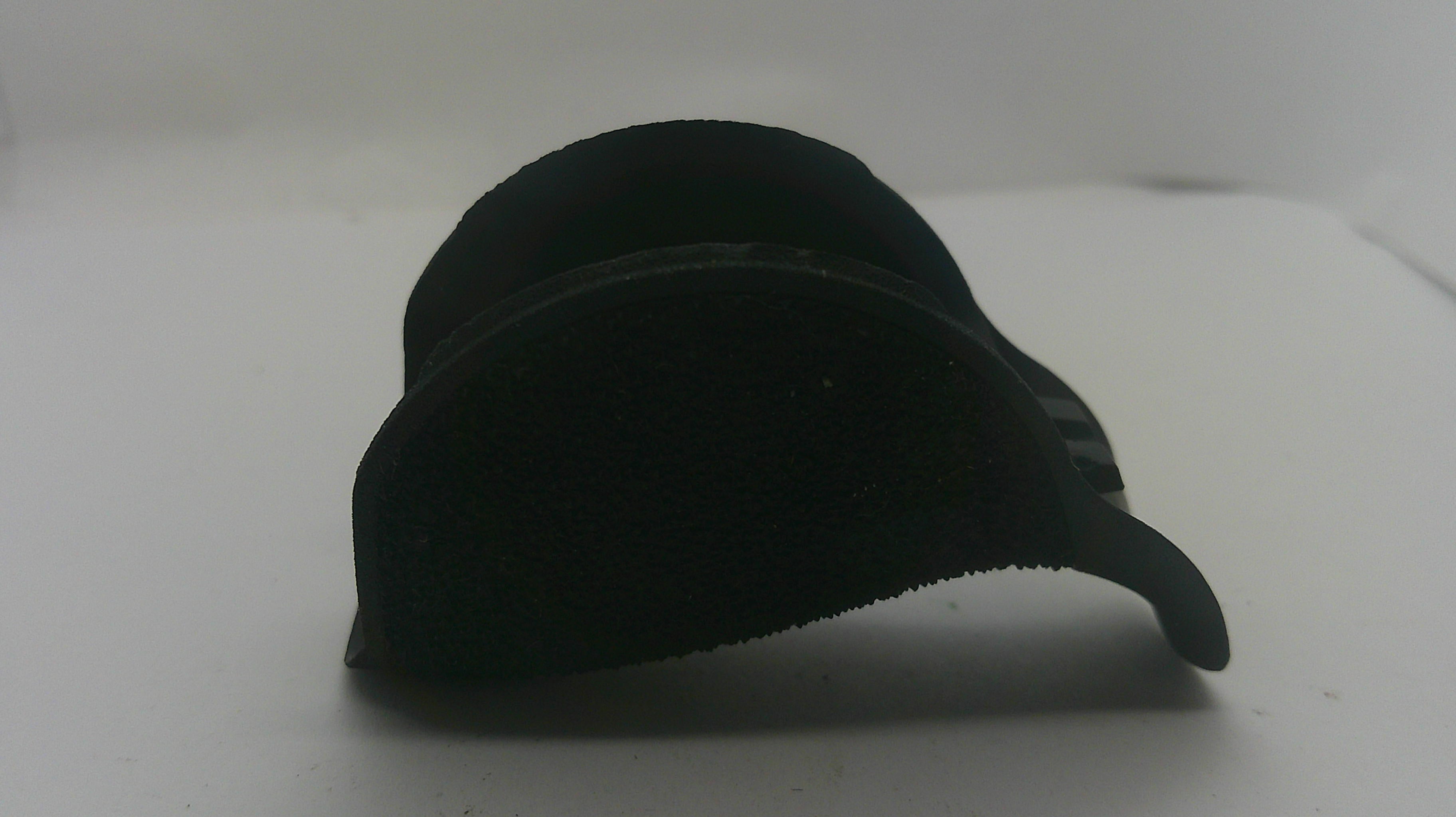 A black curved plastic accessory, possibly a protective cover or lens guard, photographed on a plain white background.