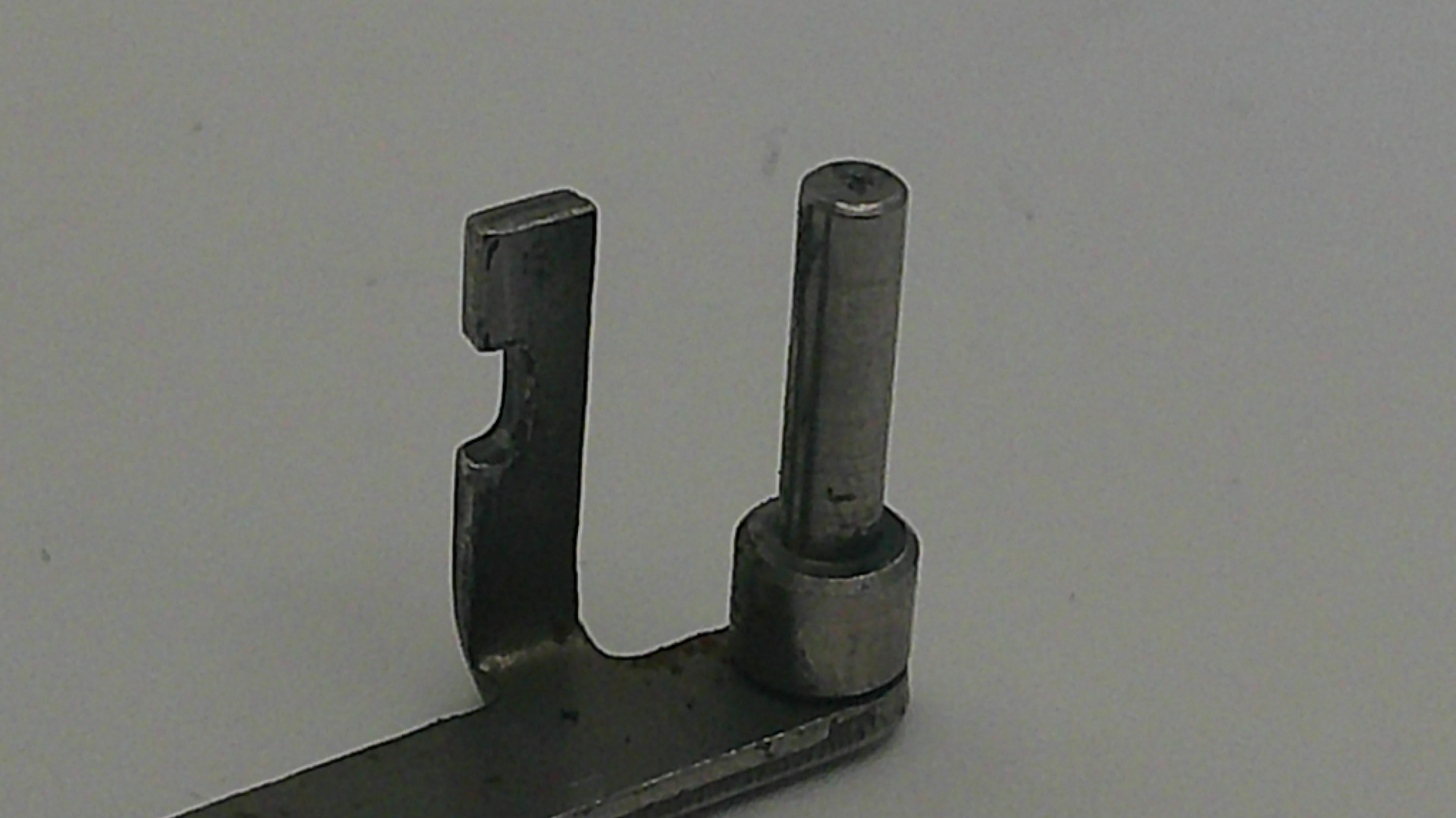 Metal mechanical component on a plain background