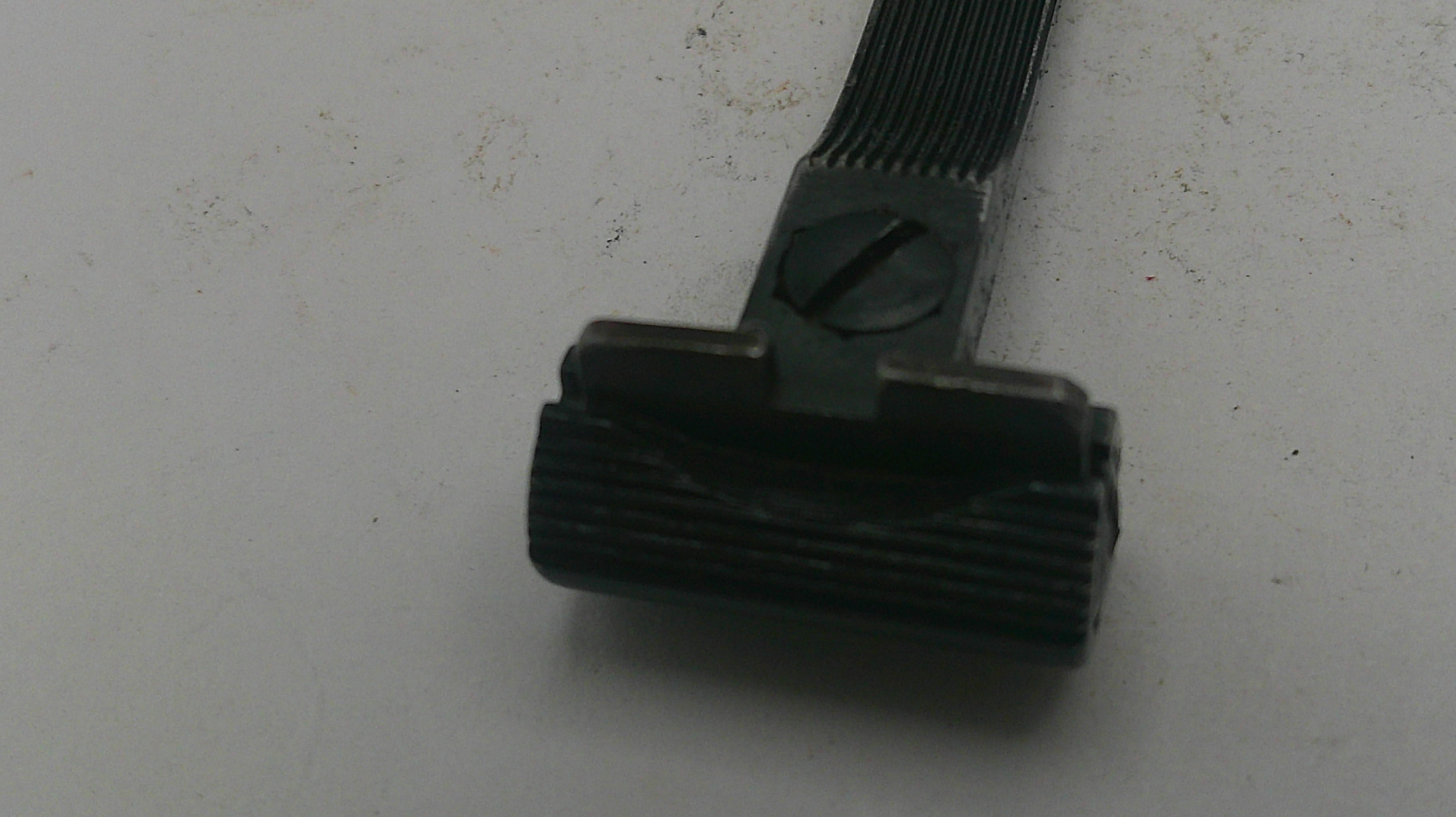 Black vacuum cleaner brush head on a light gray background