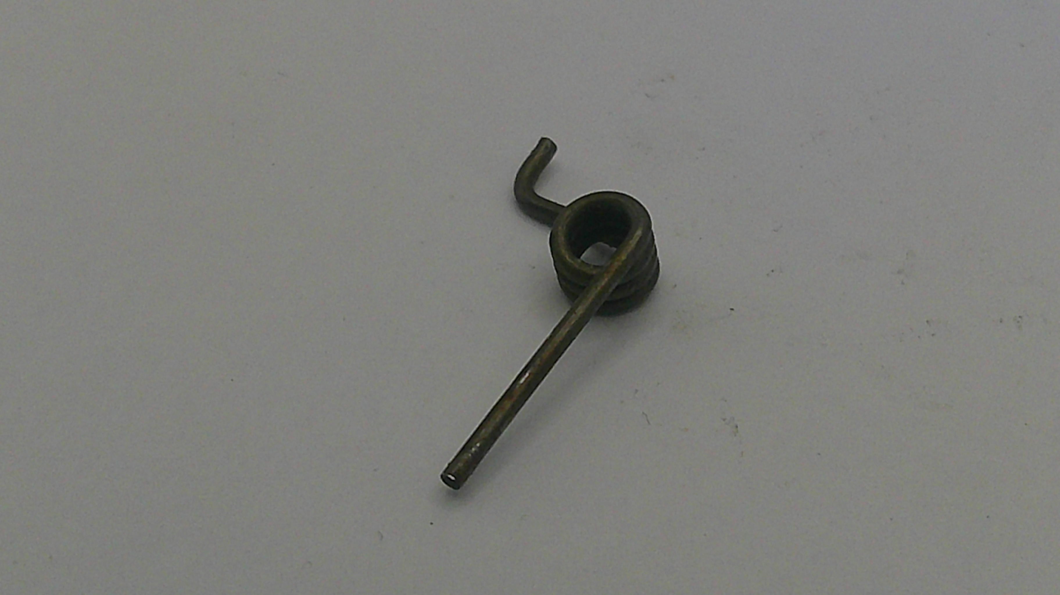 Small metallic object on a light gray background