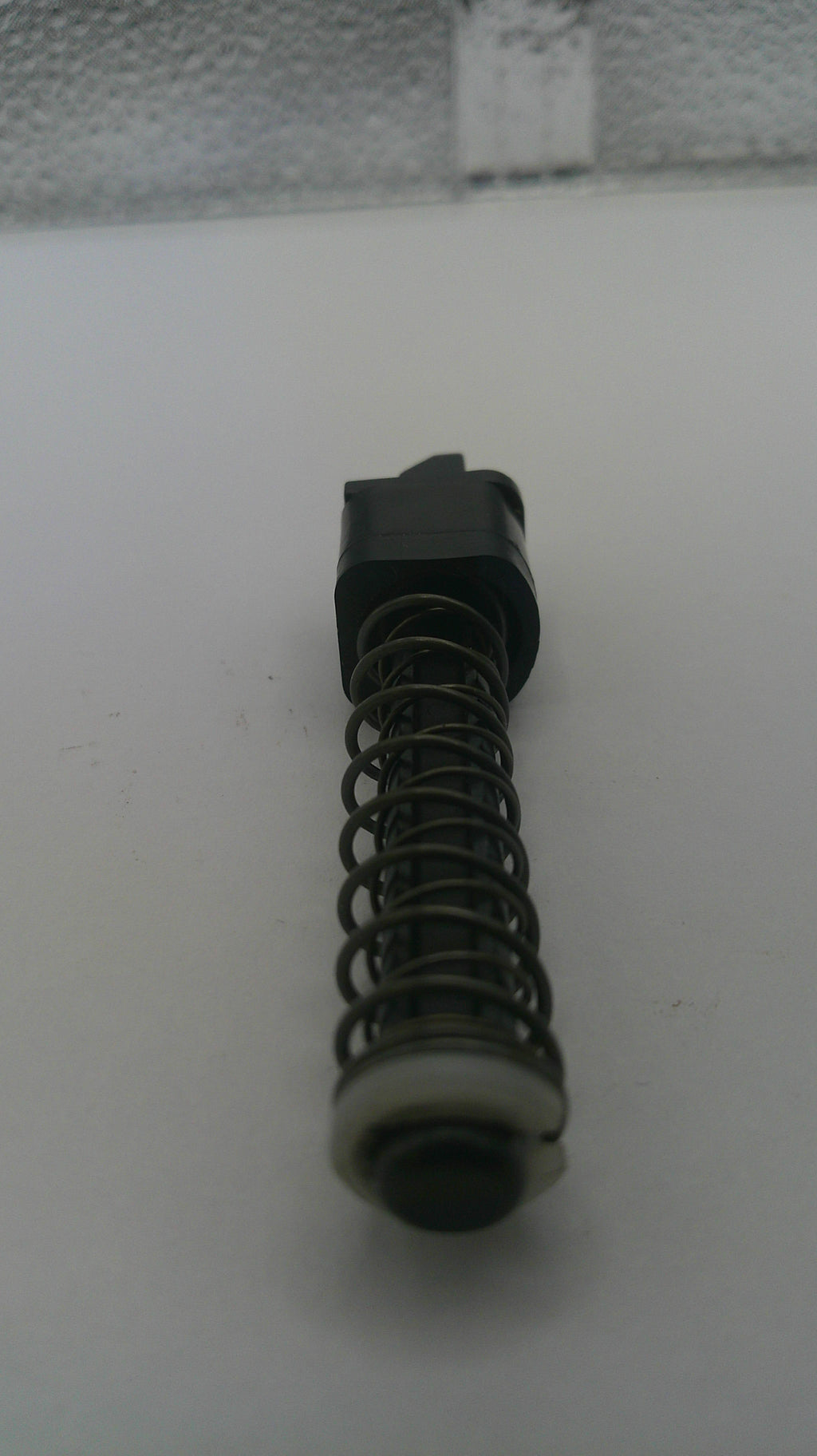 Mechanical component with a spring on a white background
