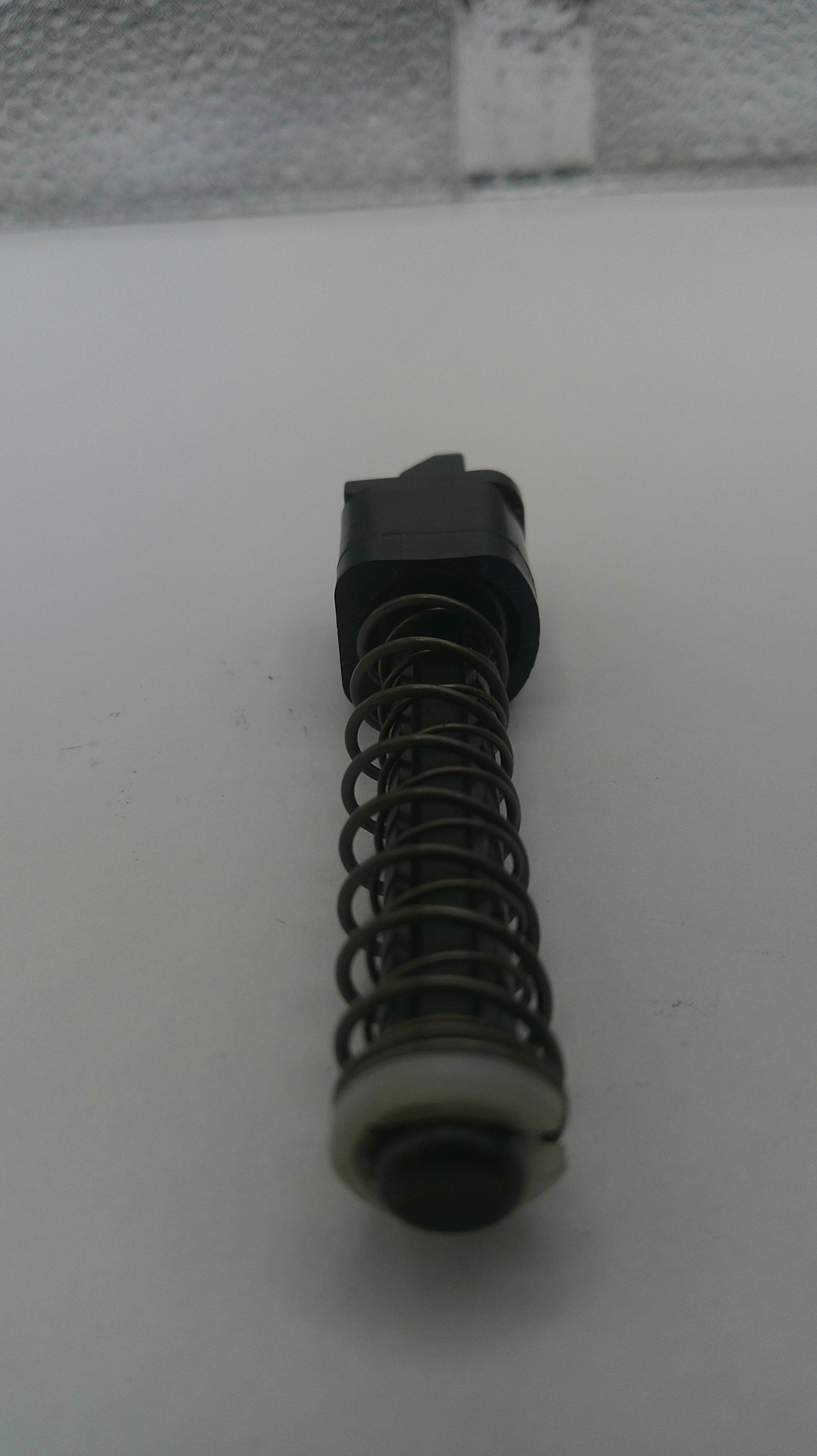 Mechanical component with a spring on a white background