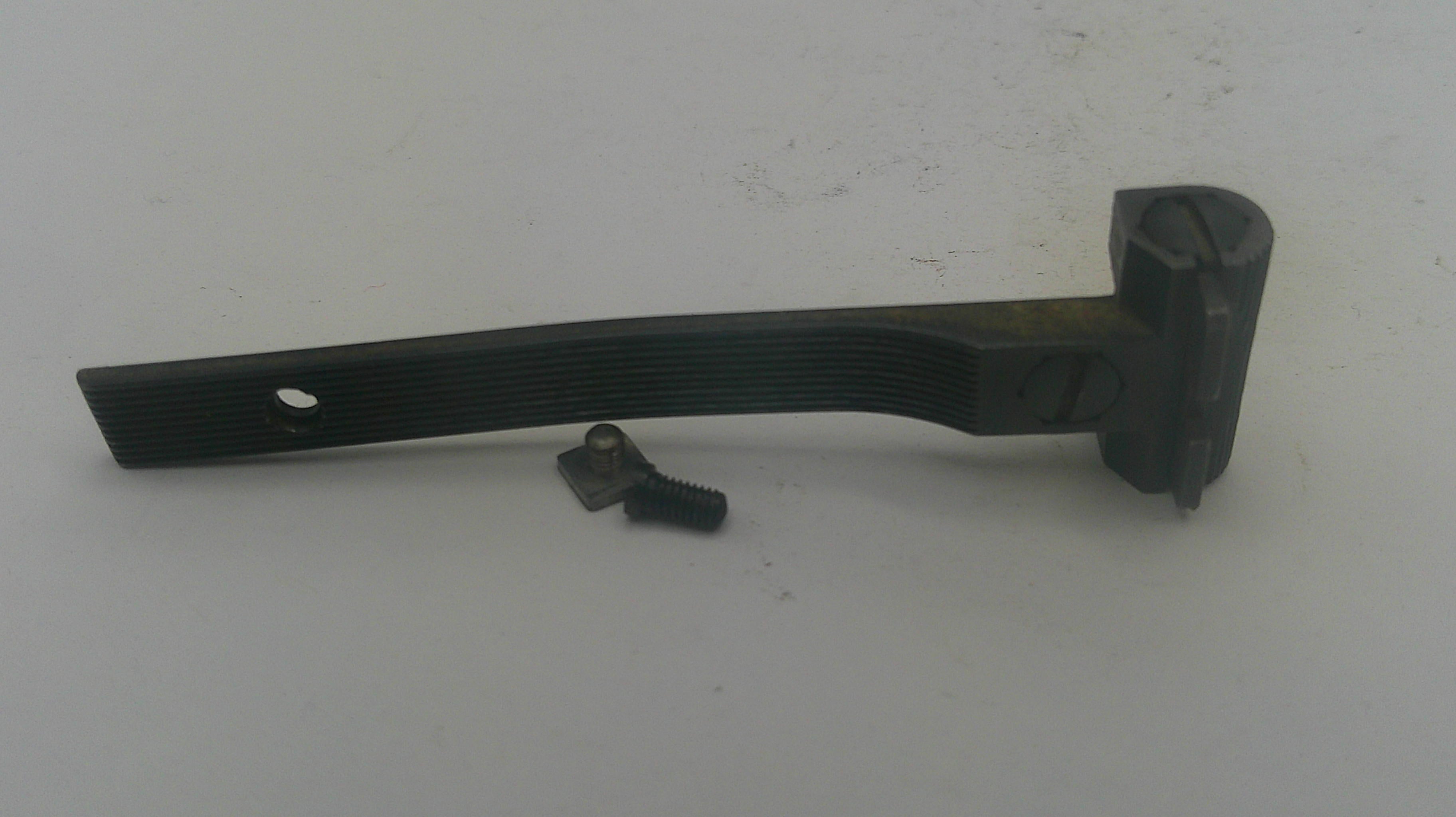 A black metal door hinge bracket with a small matching screw, shown on a plain off-white background.